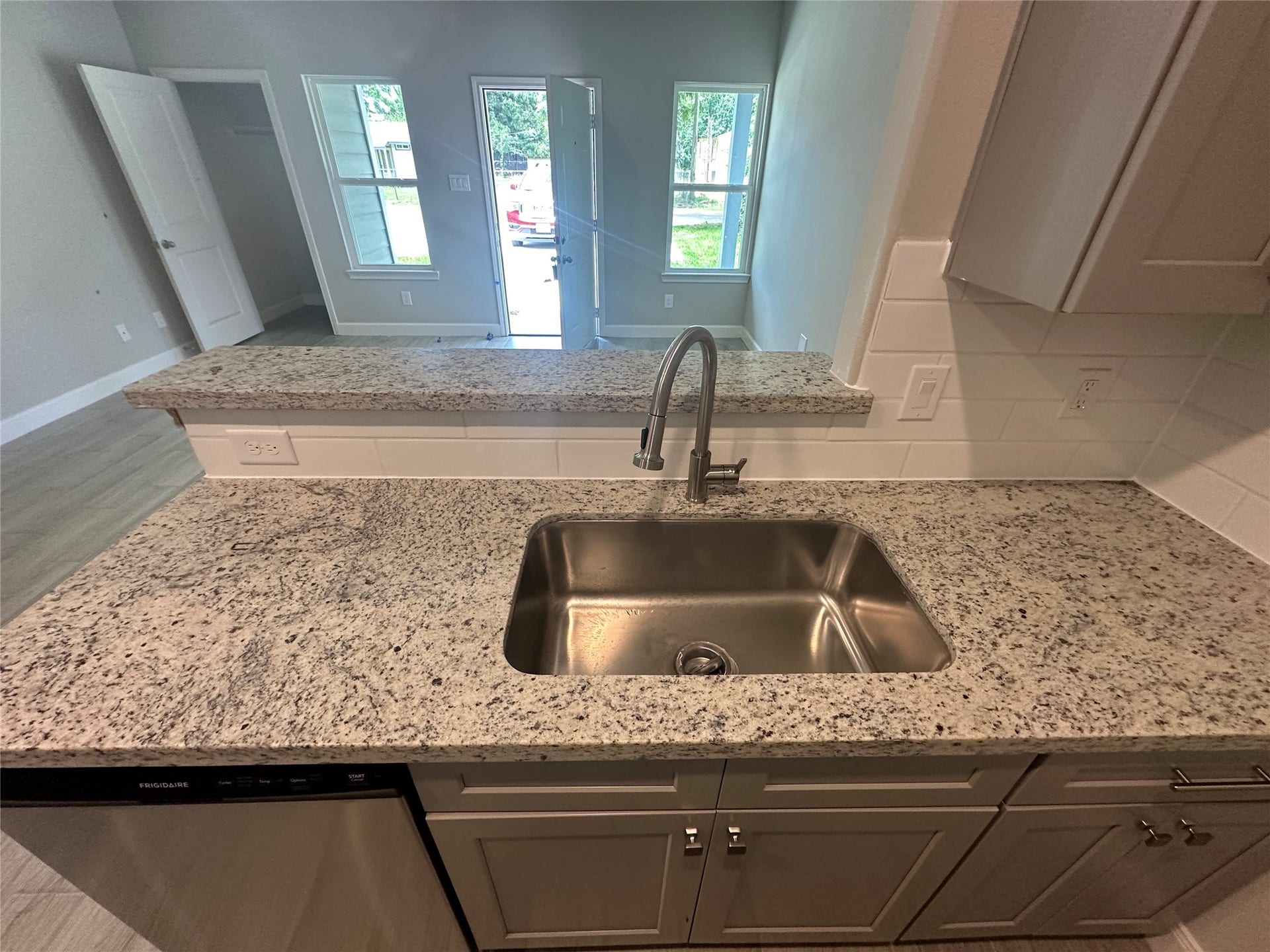 104 Turner Drive, Willis, TX 77378 Sleek granite countertops paired with an undermount stainless steel sink and modern fixtures.