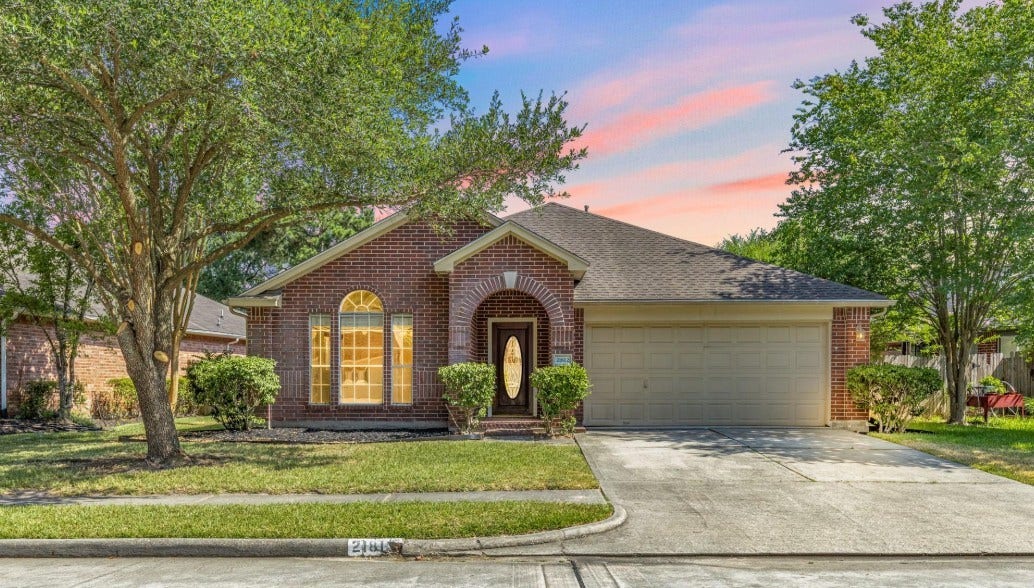21812 Whispering Forest Drive, Kingwood, TX 77339 Welcome home to this charming brick home with inviting curb appeal in the heart of Kingwood.