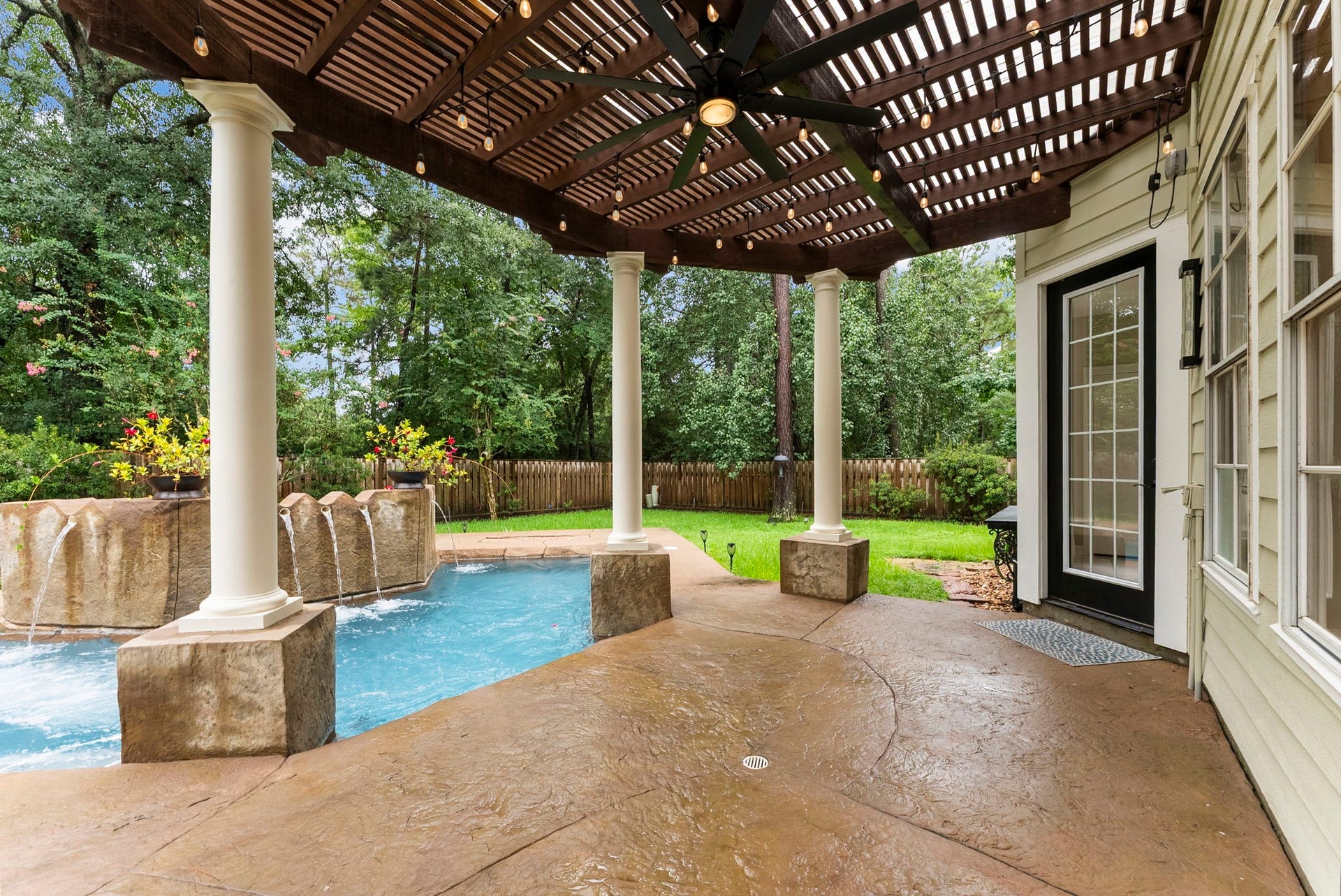 66 Candle Pine Place, The Woodlands, TX 77381 The backyard provides a swim spa along with green space.