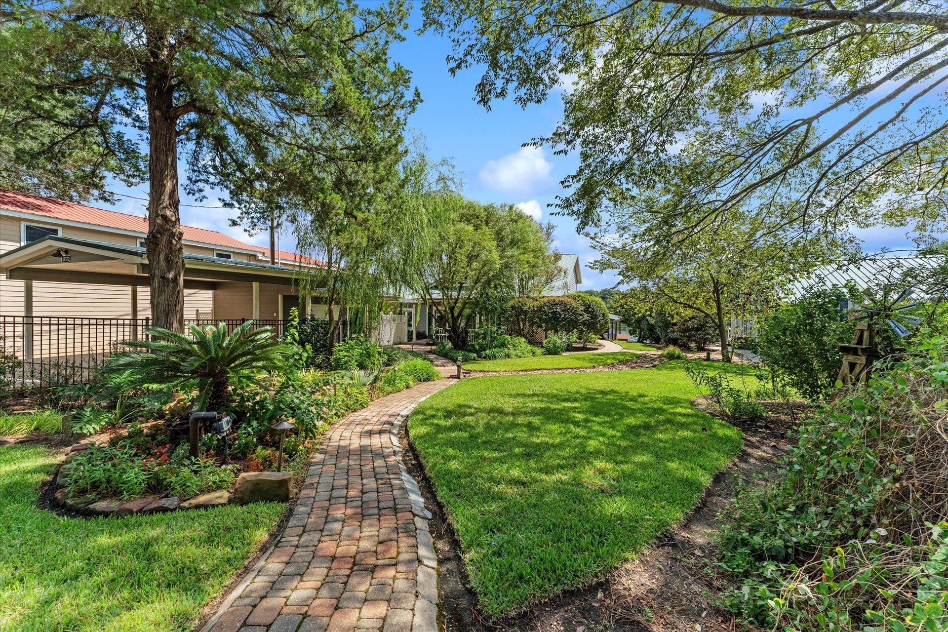 16372 Lochness Dr Drive, Willis, TX 77318 View of Car Port and detached Gym/Flex Room and the beautiful yard.