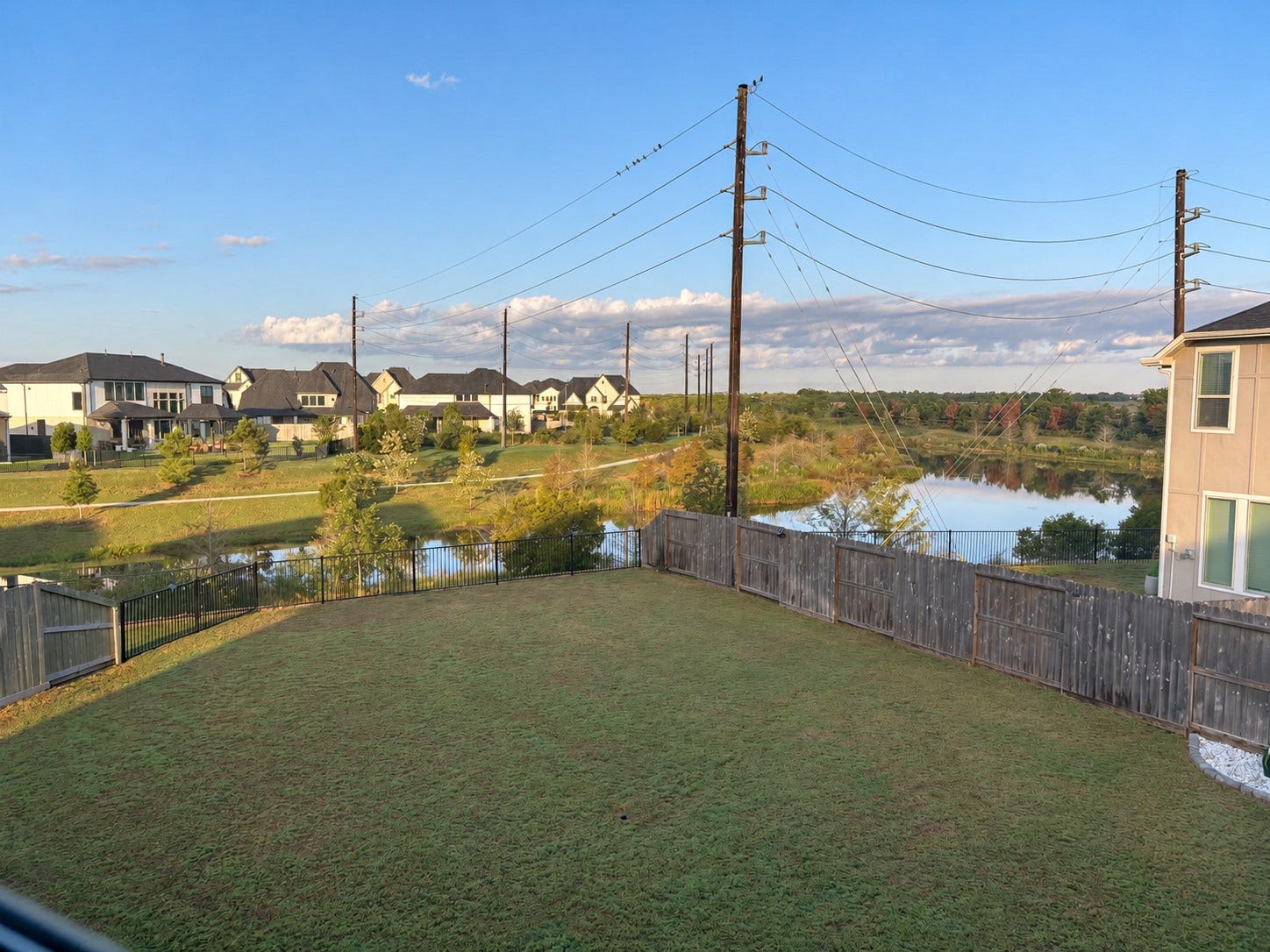 2. Spacious fenced backyard with lake views on a 7,106-square-foot lot.