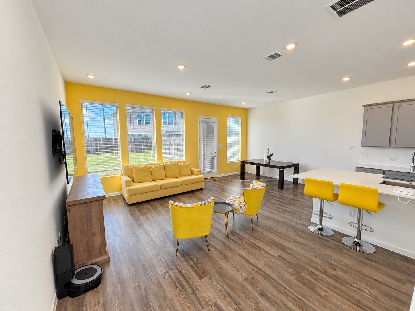 3. Open living and dining area with large windows and wood-look flooring.