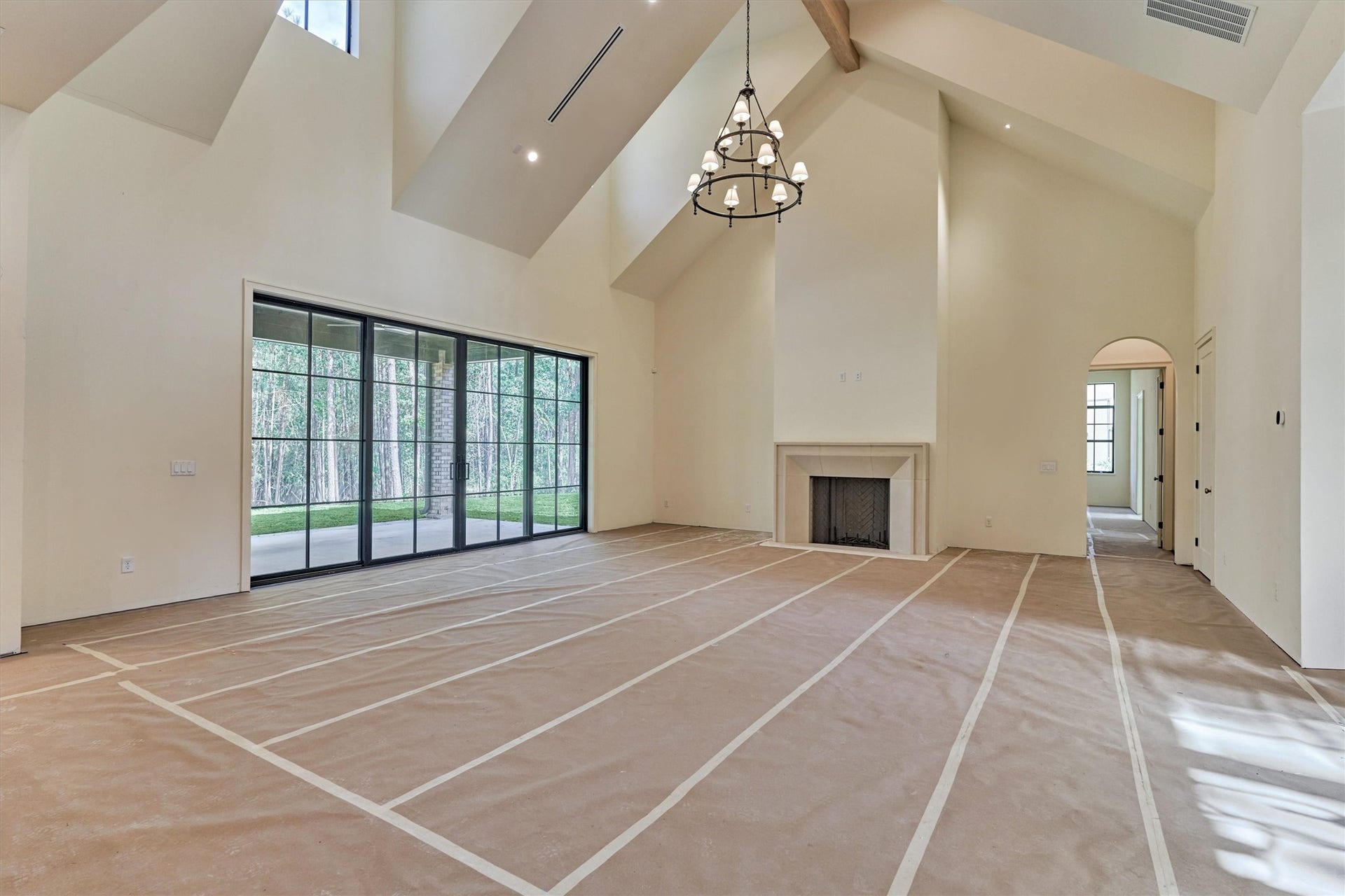 4800 Hawk Canyon Court, Montgomery, TX 77316 Construction progress highlighting the main living area, showcasing floor-to-ceiling fireplace that defines the space with architectural elegance.