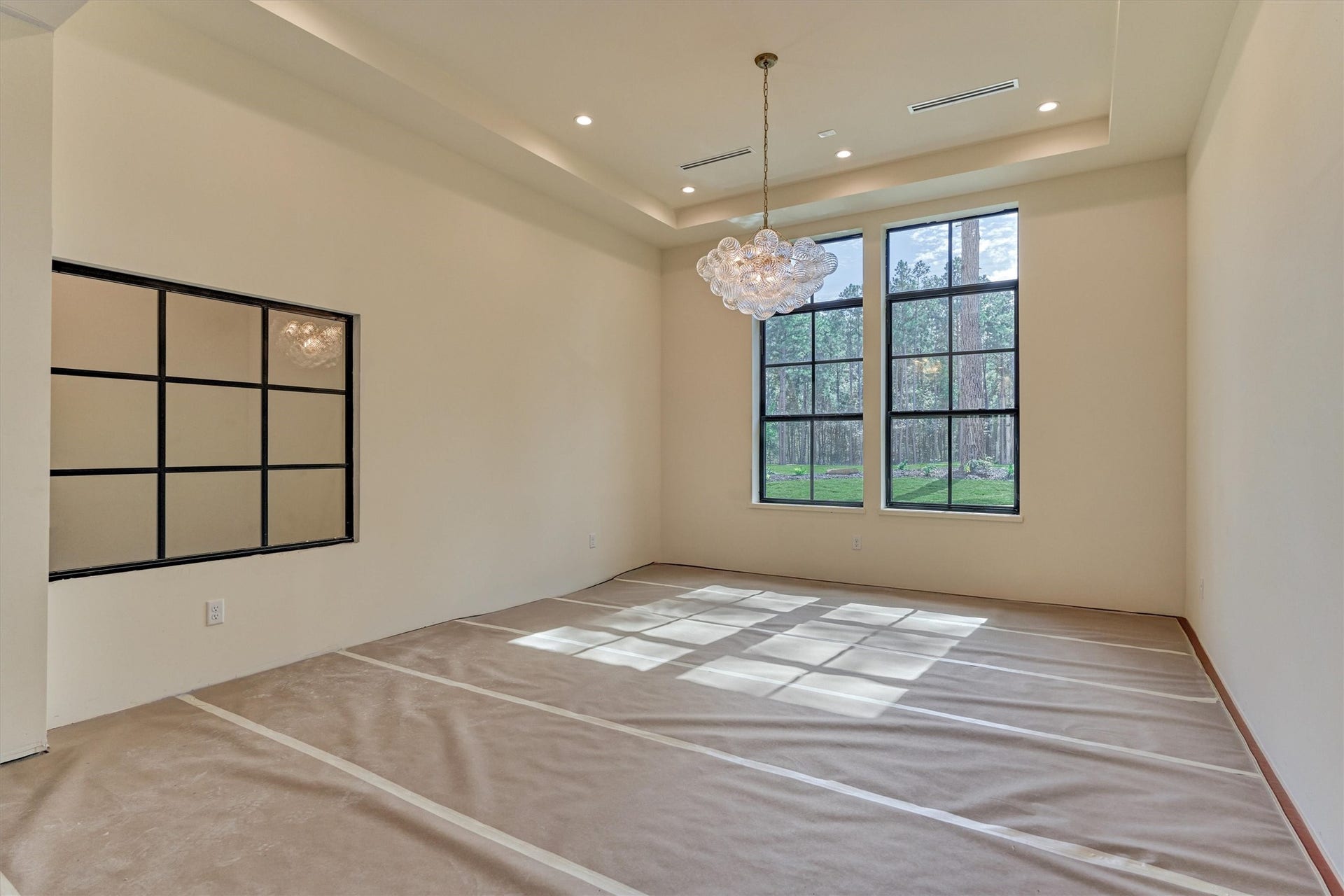 4800 Hawk Canyon Court, Montgomery, TX 77316 An elegant dining space complemented by a stunning glass enclosed private wine cellar, thoughtfully integrated beneath the staircase.