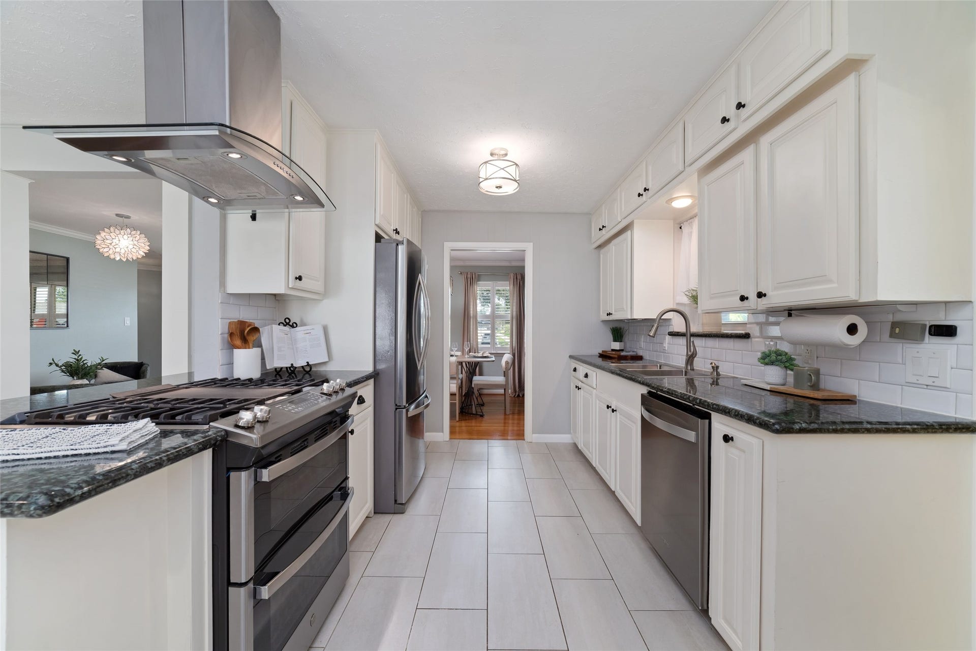 2127 Lazybrook Drive, Houston, TX 77008 Kitchen offers ample cabinet space, granite countertops and stainless steel appliances.
