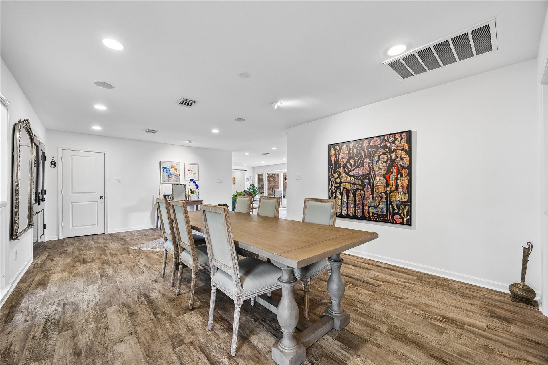 4703 Banning Drive, Houston, TX 77027 Dining area offers wonderful space for hosting gatherings, w/an open layout connecting to the kitchen & living areas. Neutral walls, recessed lighting & continuous wood-look flooring create a seamless flow throughout.