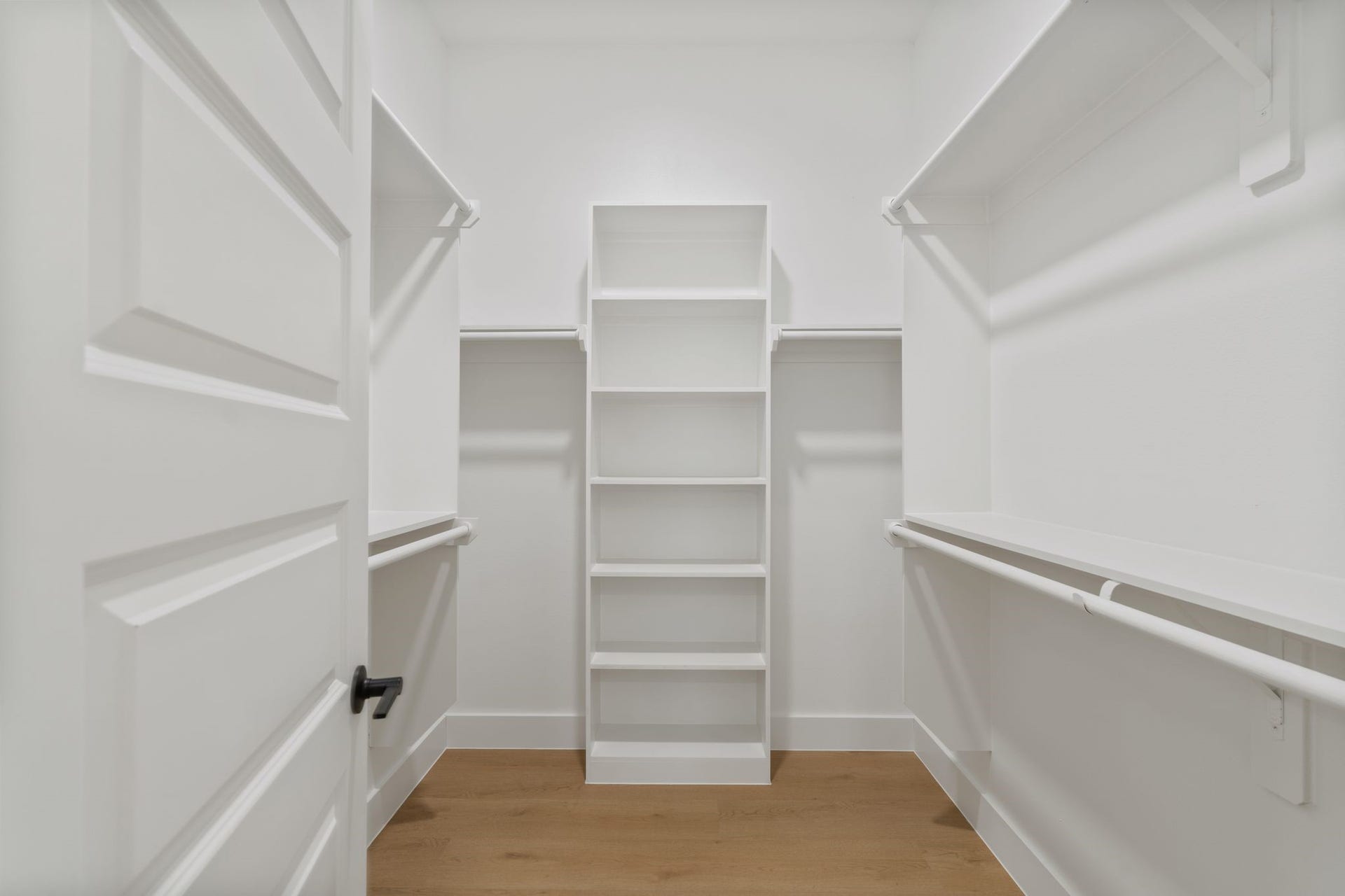 Spacious walk-in closet featuring ample shelving and hanging space, perfect for organized storage and easy access to your wardrobe essentials.