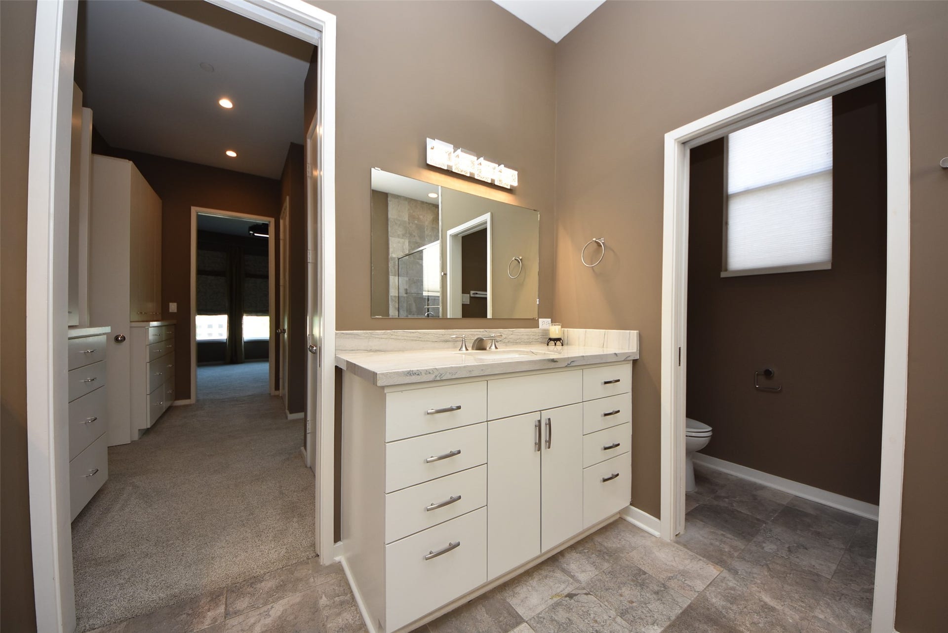 6519 Durford Street, Houston, TX 77007 Built-in cabinetry between the primary bedroom and bathroom, offering additional storage and convenience.