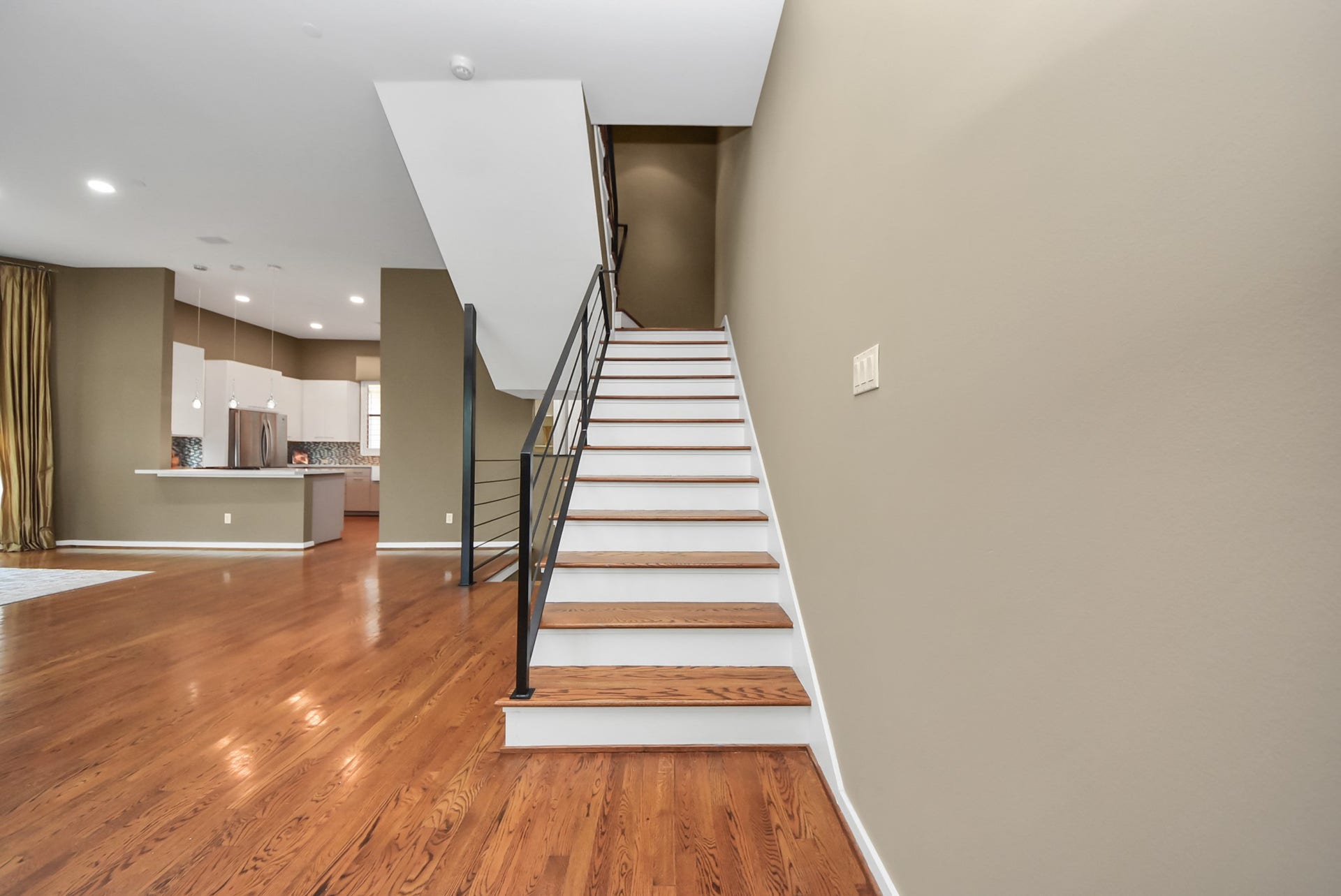 6519 Durford Street, Houston, TX 77007 Elegant staircase from the second floor leading to the third level, where the spacious primary suite, study, and private retreat await.
