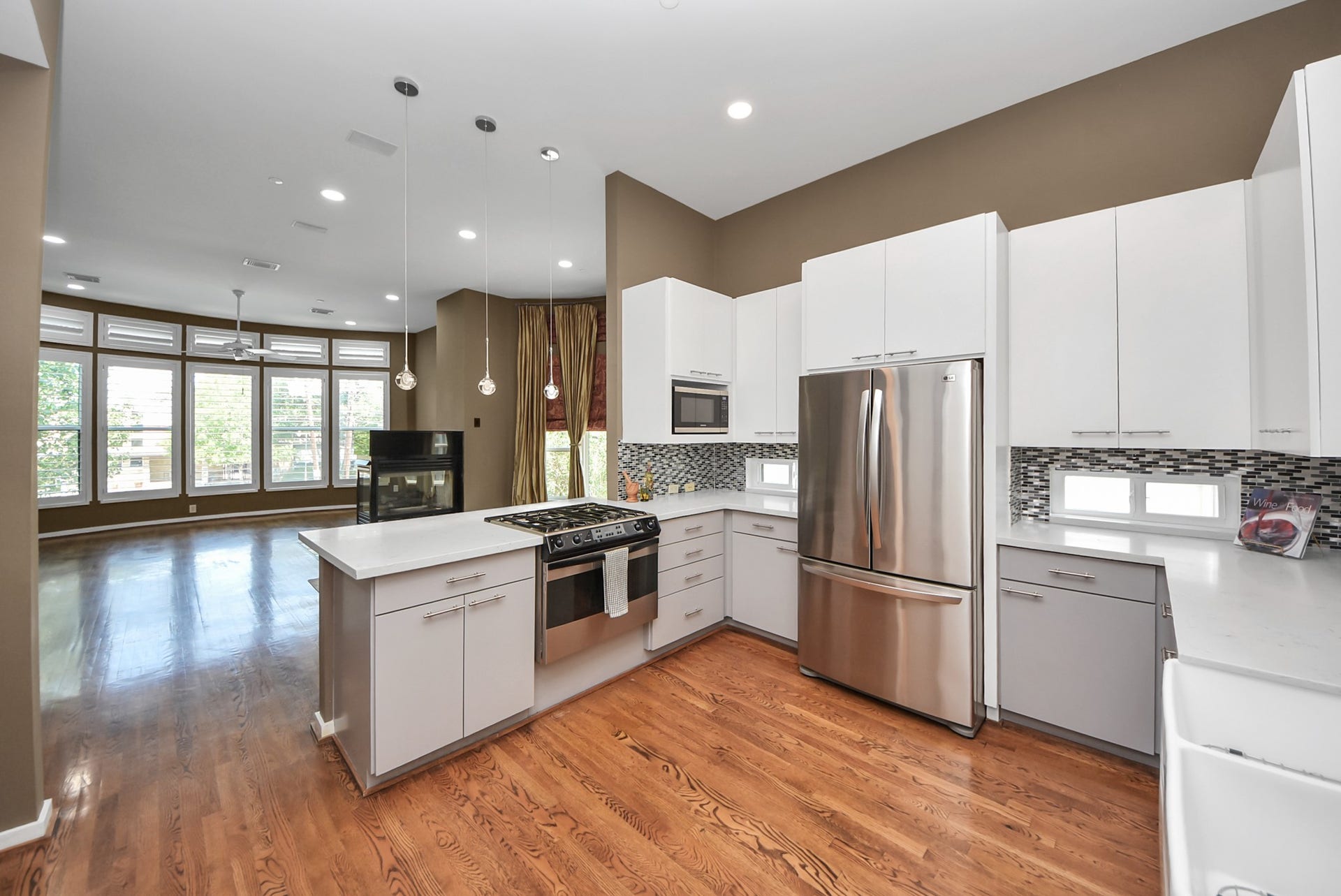 6519 Durford Street, Houston, TX 77007 Stylish kitchen with stainless steel appliances, sleek cabinetry, and a spacious island that opens seamlessly to the living areaperfect for entertaining.