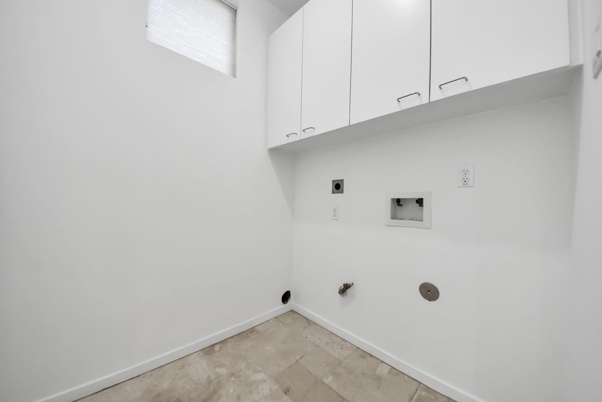 6519 Durford Street, Houston, TX 77007 Convenient first-floor laundry room featuring built-in cabinetry and ample space for washer and dryer.