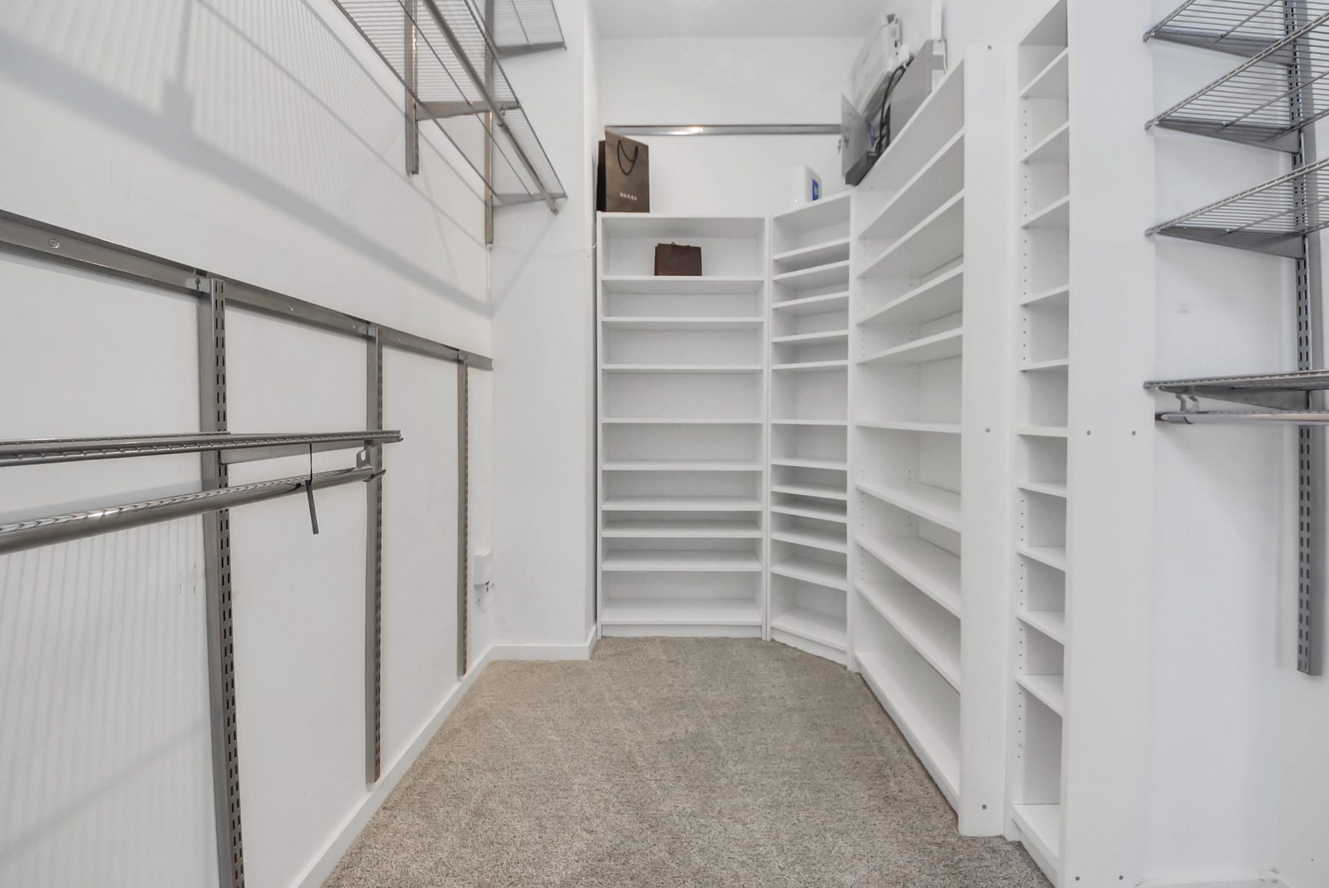 6519 Durford Street, Houston, TX 77007 Spacious primary closet with extensive built-in shelving and hanging space