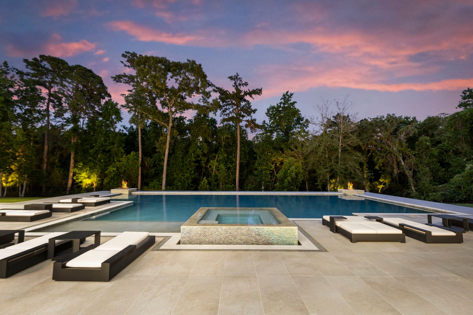 True resort-style backyard is framed by a dense nature preserve for absolute privacy.