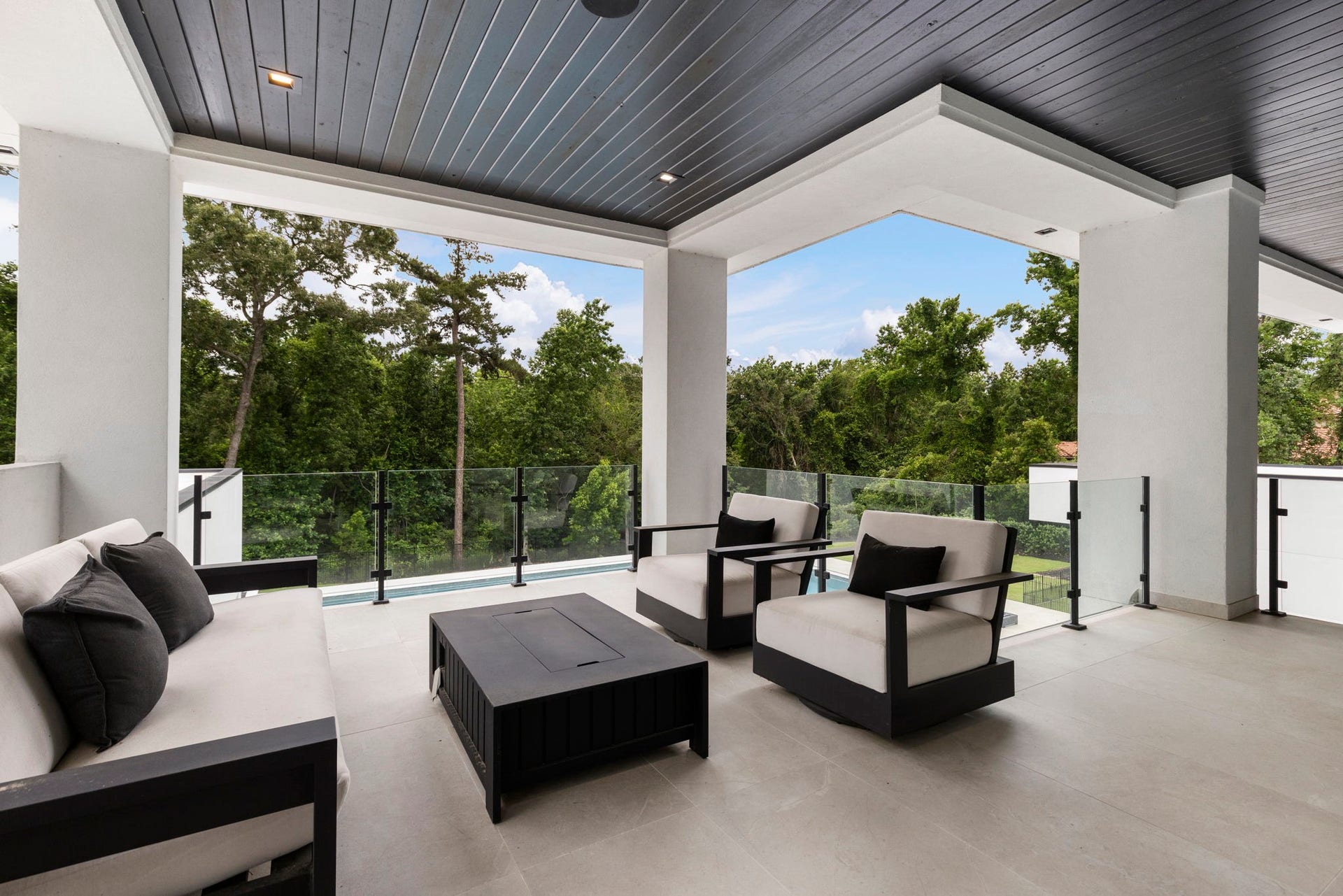 The balcony overs serene views of a lush, private backdrop.
