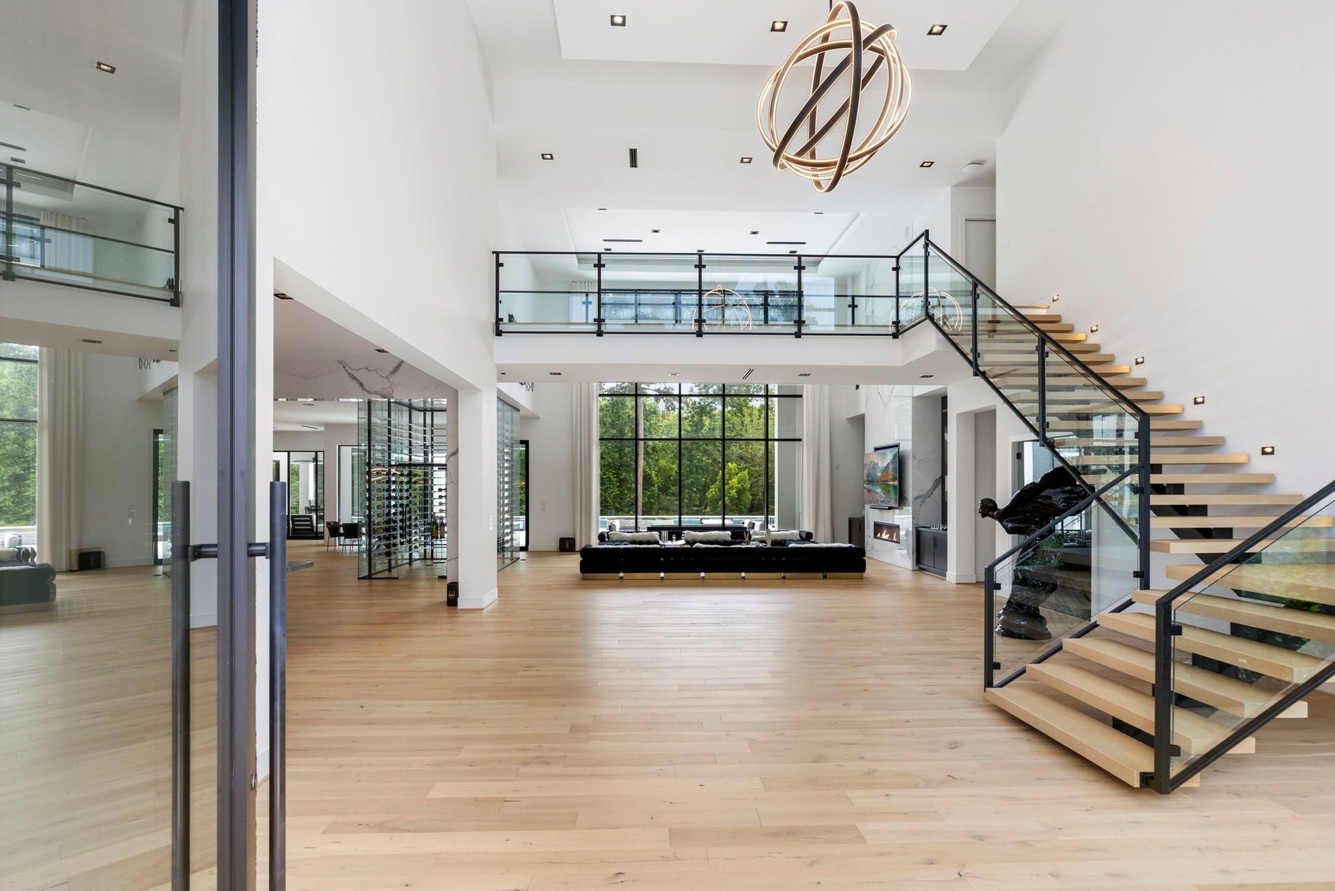 High ceilings with crisp clean neutral walls compliment white oak flooring and an eye catching floating staircase.