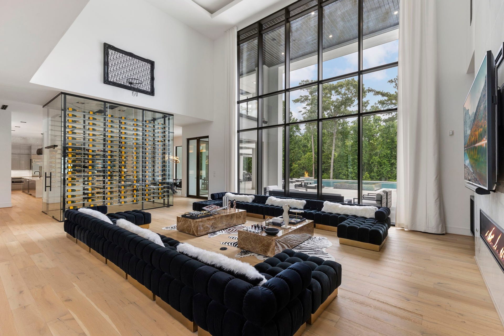 Dramatic floor-to-ceiling windows define this spectacular living space, filling the interior with natural light.