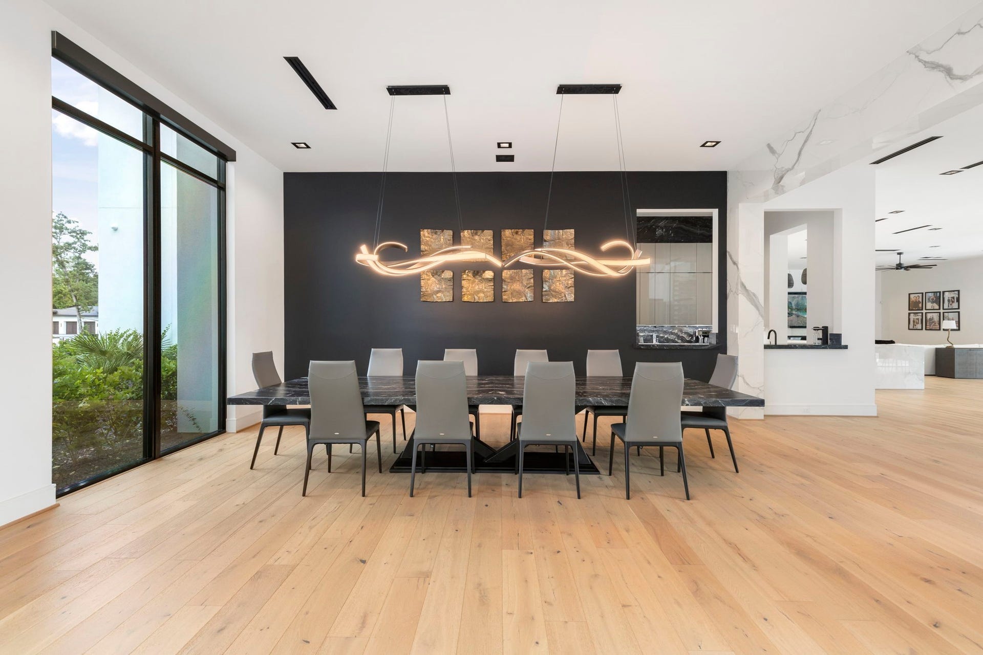 Off the entry, the formal dining offers clean, sleek lines. Steps away is a well thought butler pantry and full service bar.