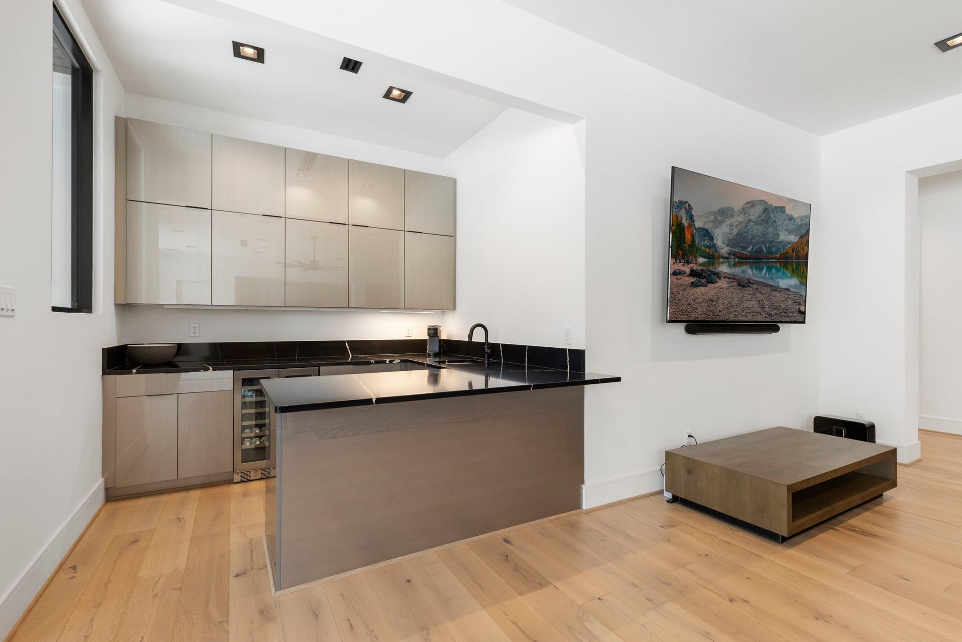 Bar offers generous storage, wine chiller, sink and mini fridge.