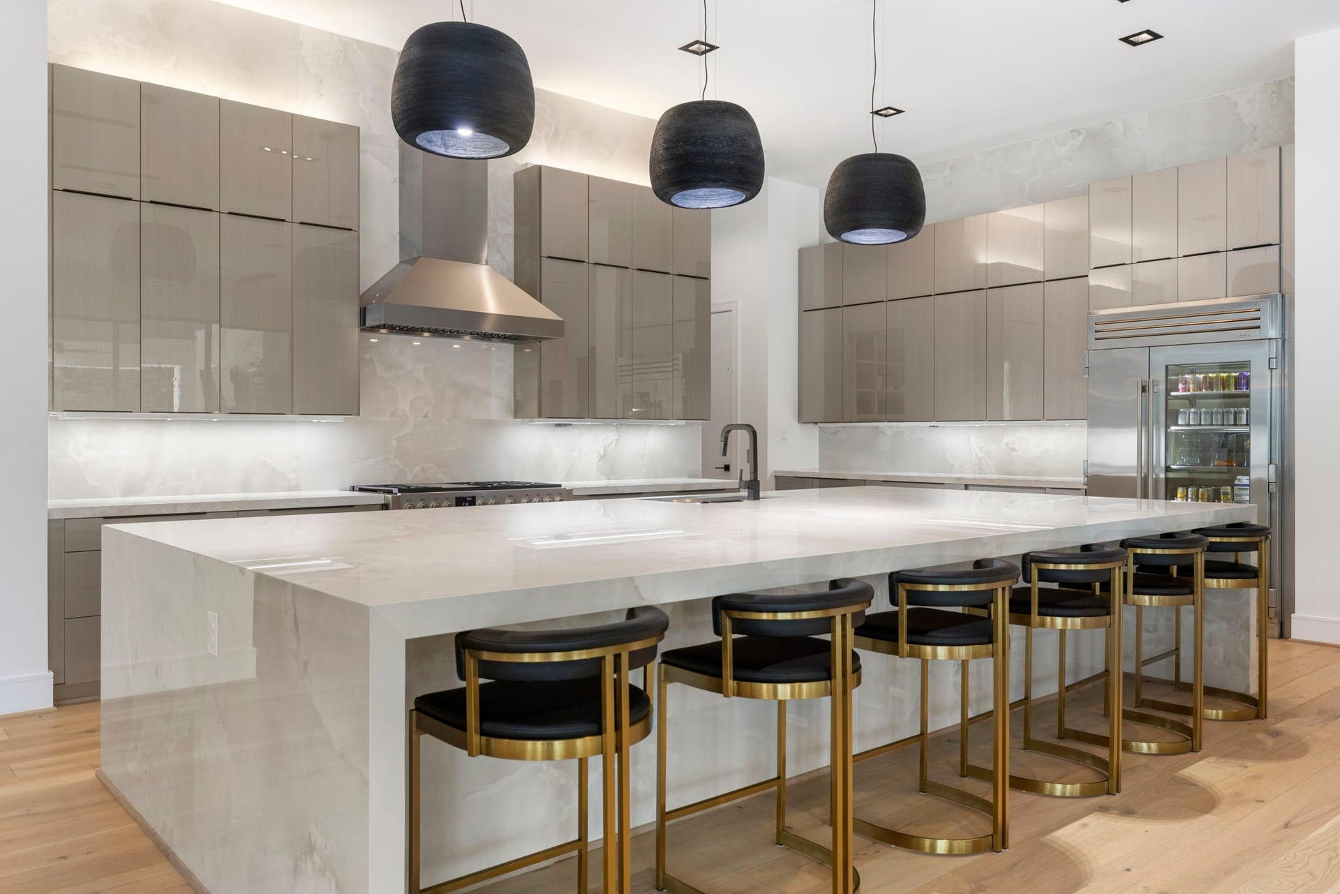 The kitchen is defined by its clean geometric lines and outfitted with high-performance Italian appliances and Dekton cabinetry.