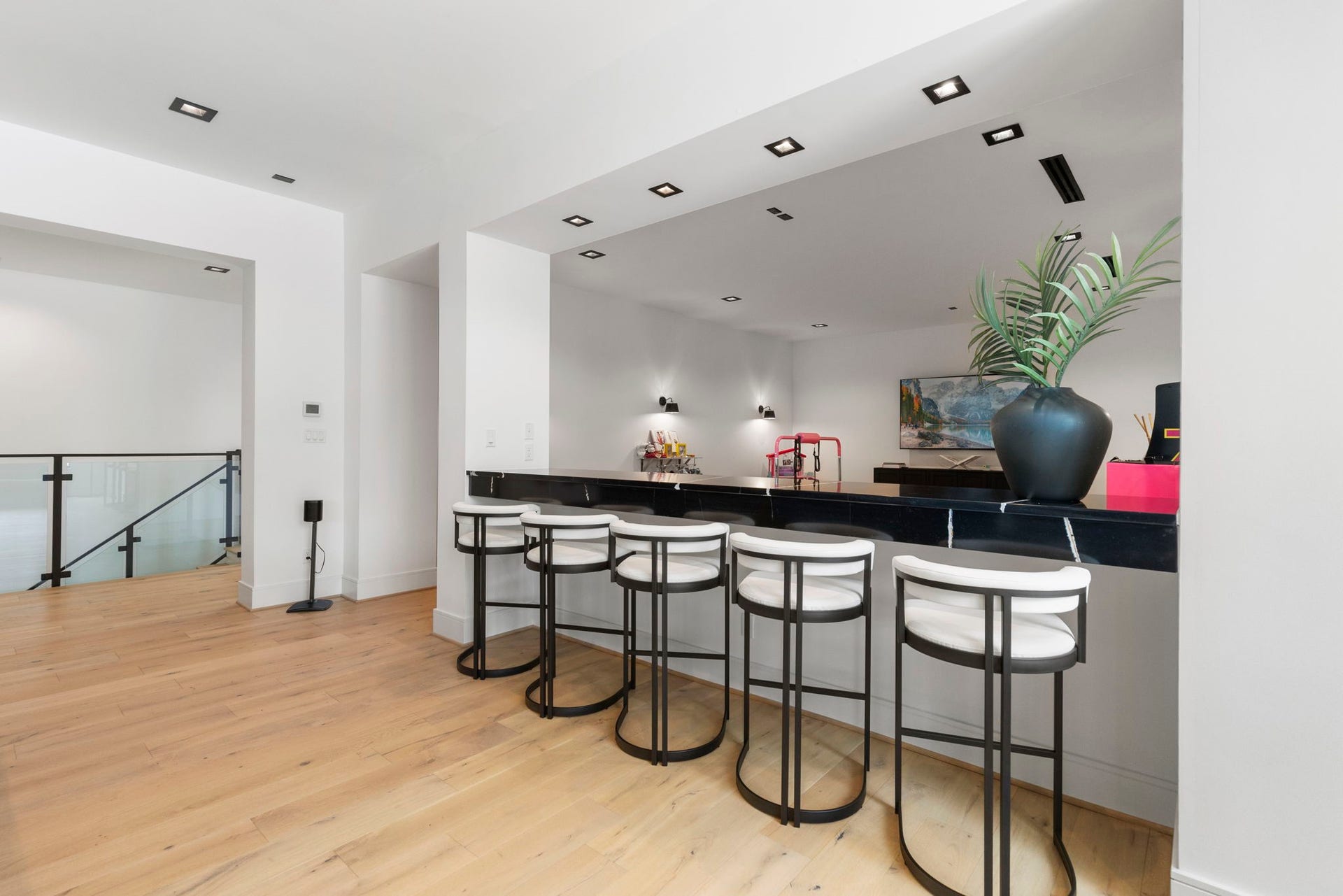 Additional bar height seating overlooks a secondary flex space.