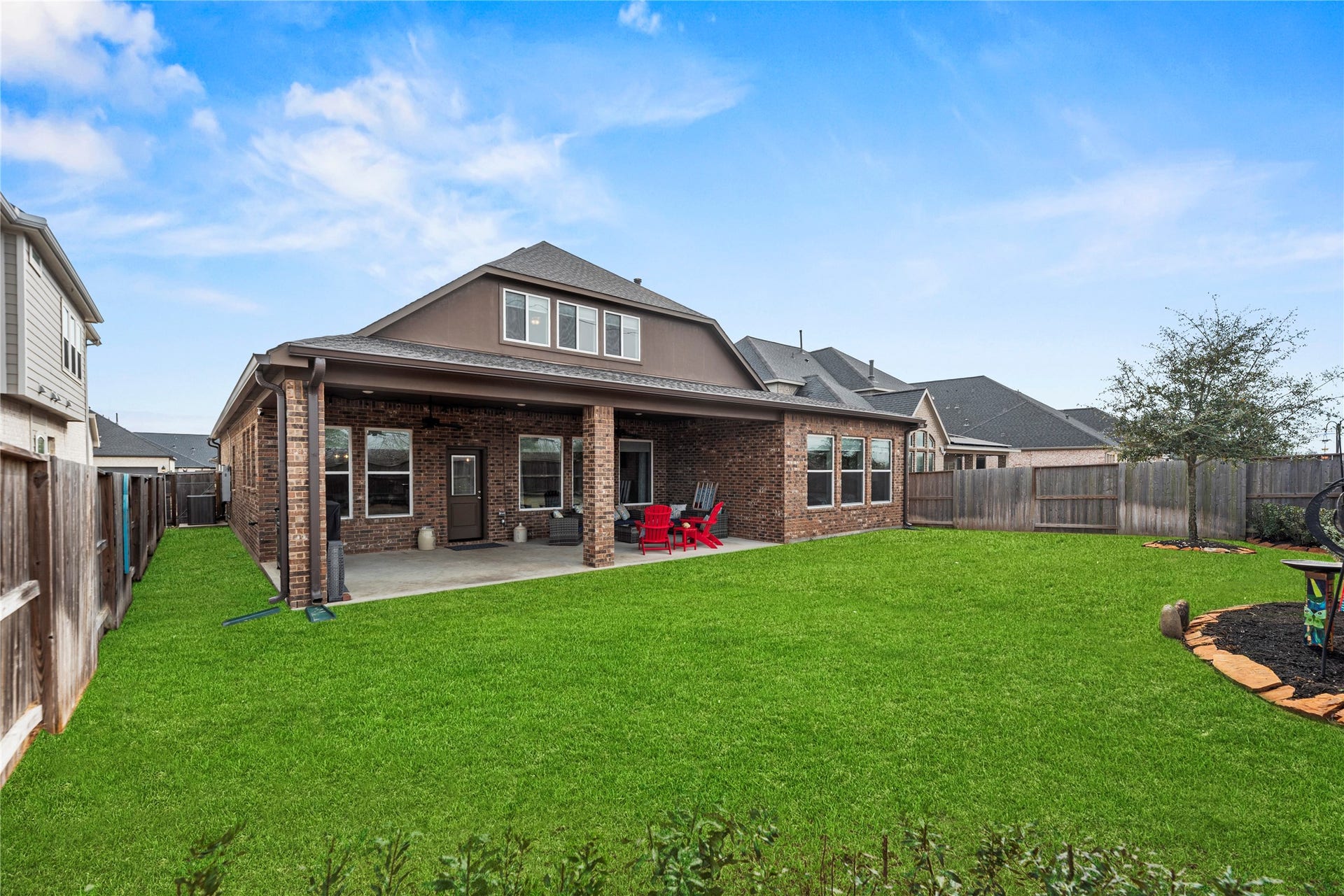 3127 Swift Way, Katy, TX 77493 Spacious backyard with a covered patio perfect for outdoor gatherings, surrounded by a privacy fence and lush green lawn.