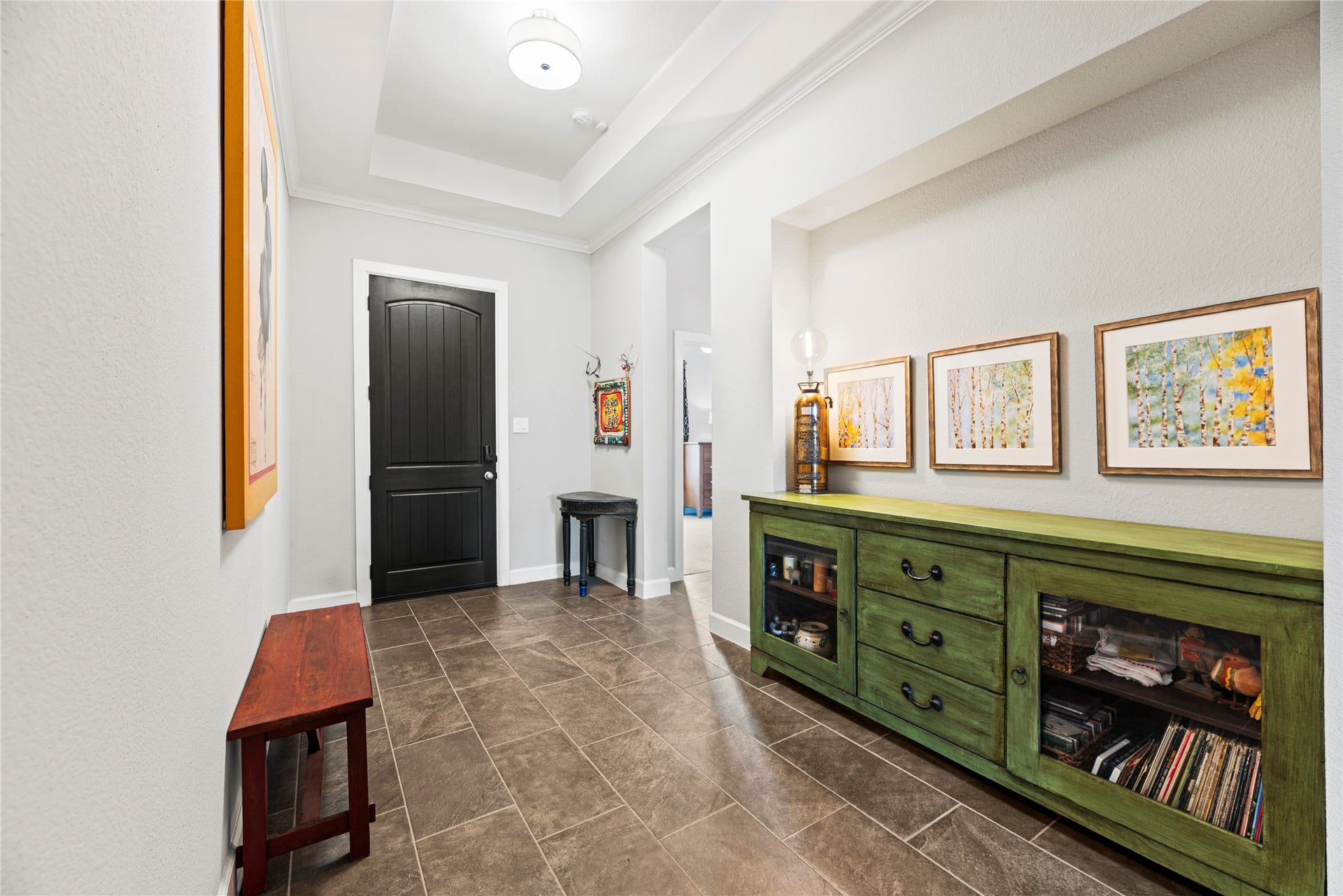 3127 Swift Way, Katy, TX 77493 Inviting foyer with elegant tile flooring and a striking dark wood door.