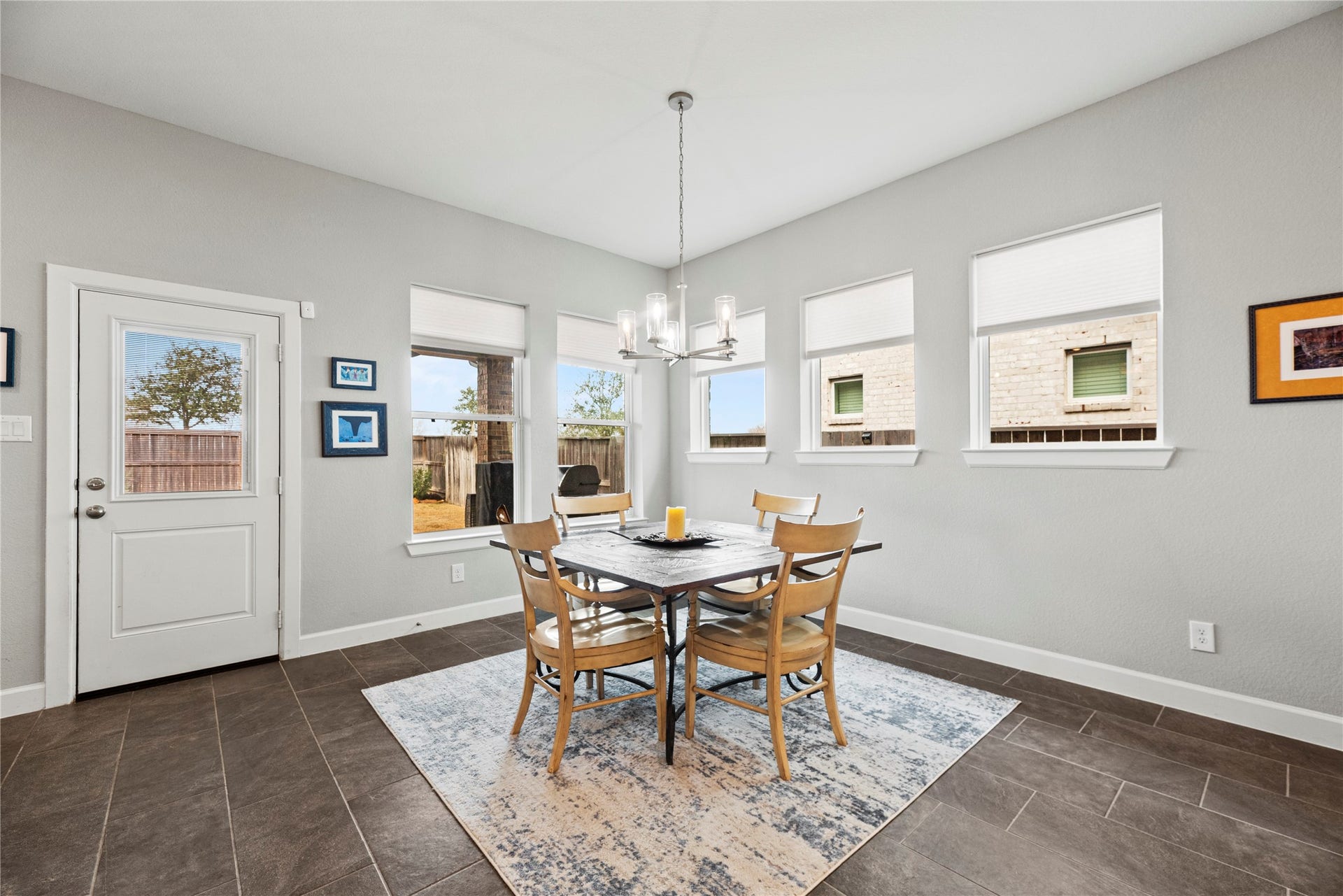 3127 Swift Way, Katy, TX 77493 Bright and inviting dining area with large windows, stylish light fixture, and access to the backyard, perfect for meals and entertaining.