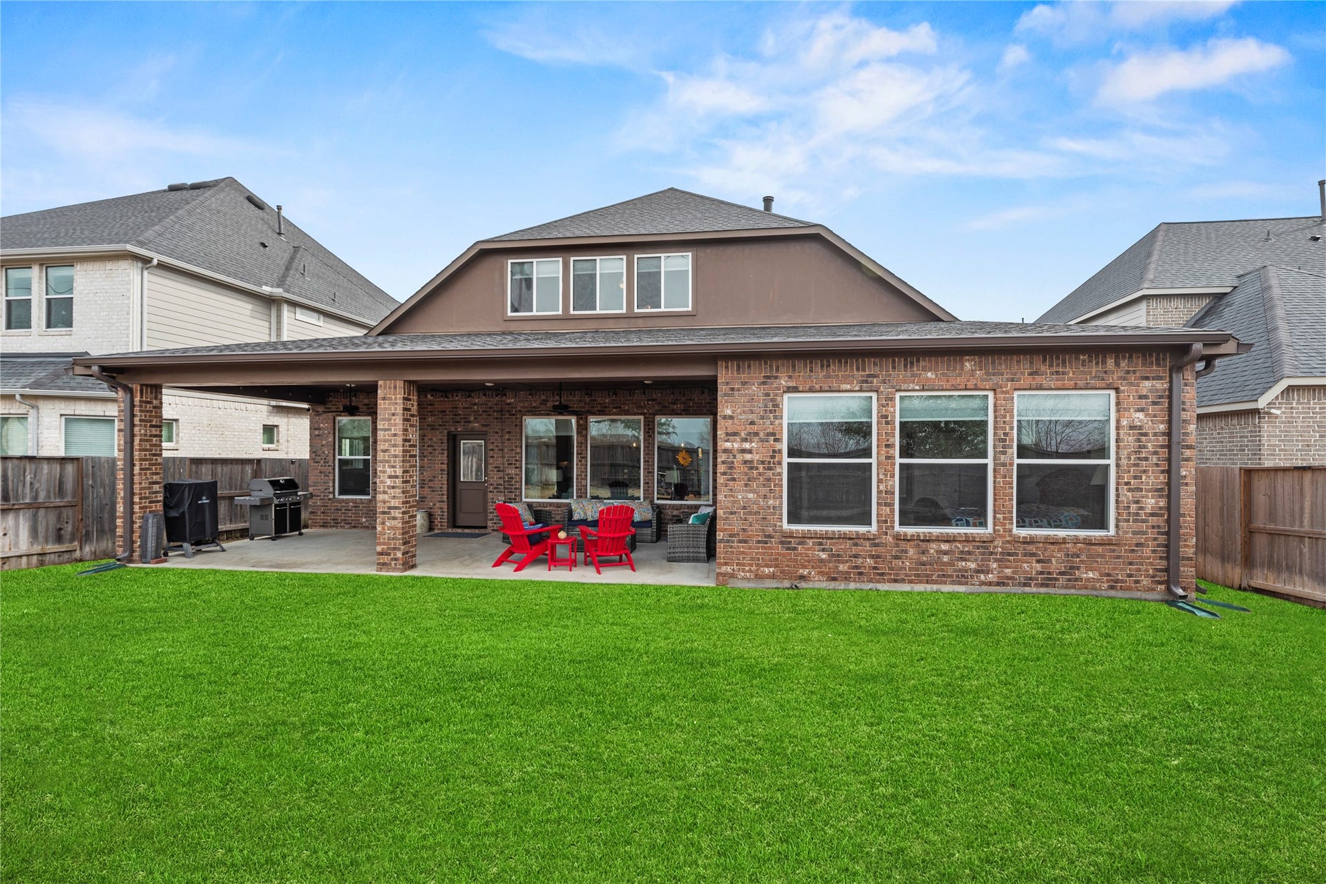 3127 Swift Way, Katy, TX 77493 NO back neighbors! Spacious backyard with a covered patio perfect for outdoor entertaining, featuring a brick exterior and large windows for plenty of natural light.