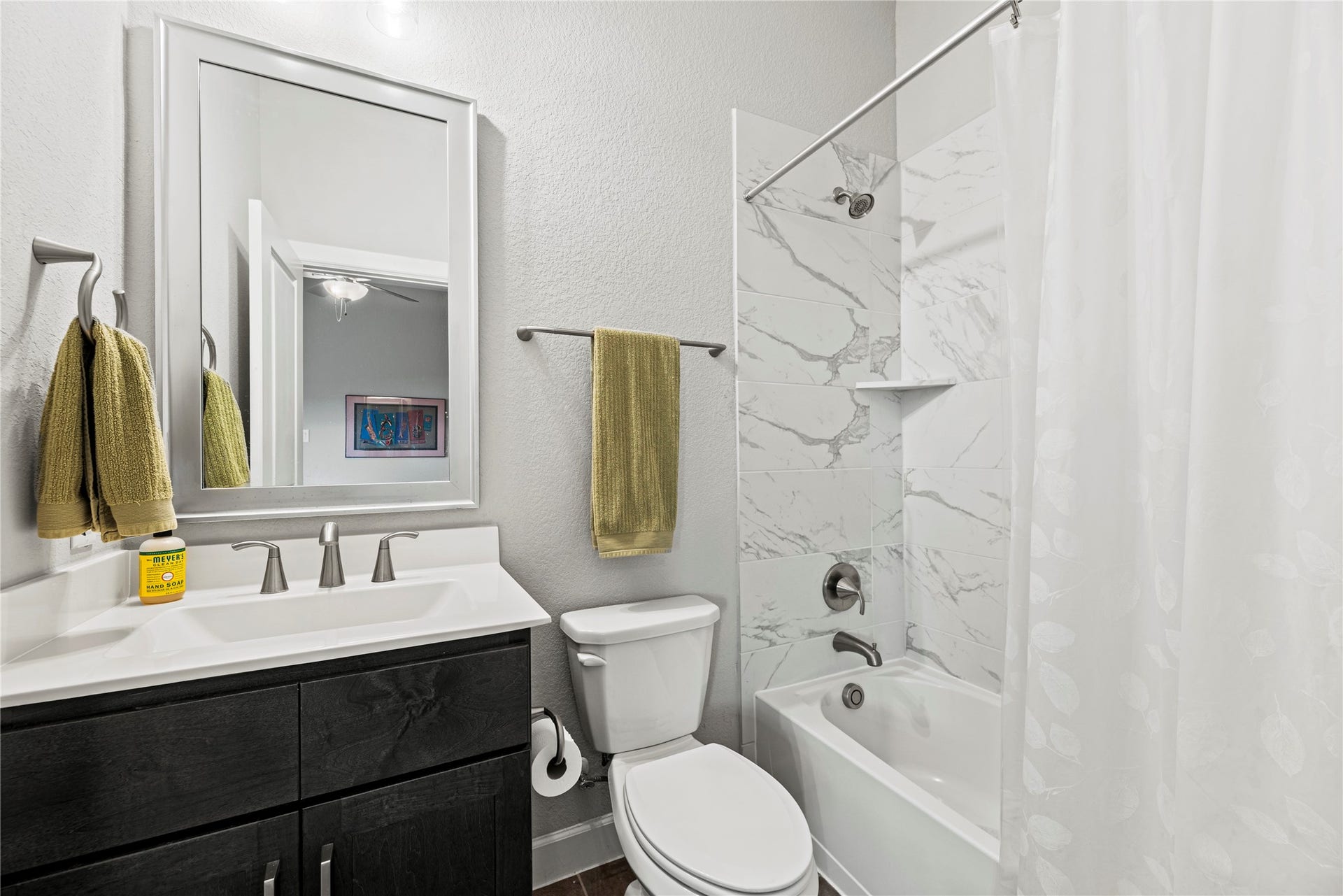 3127 Swift Way, Katy, TX 77493 Chic fourth bathroom featuring a sleek vanity, elegant tile in the shower, and modern fixtures for a touch of luxury.