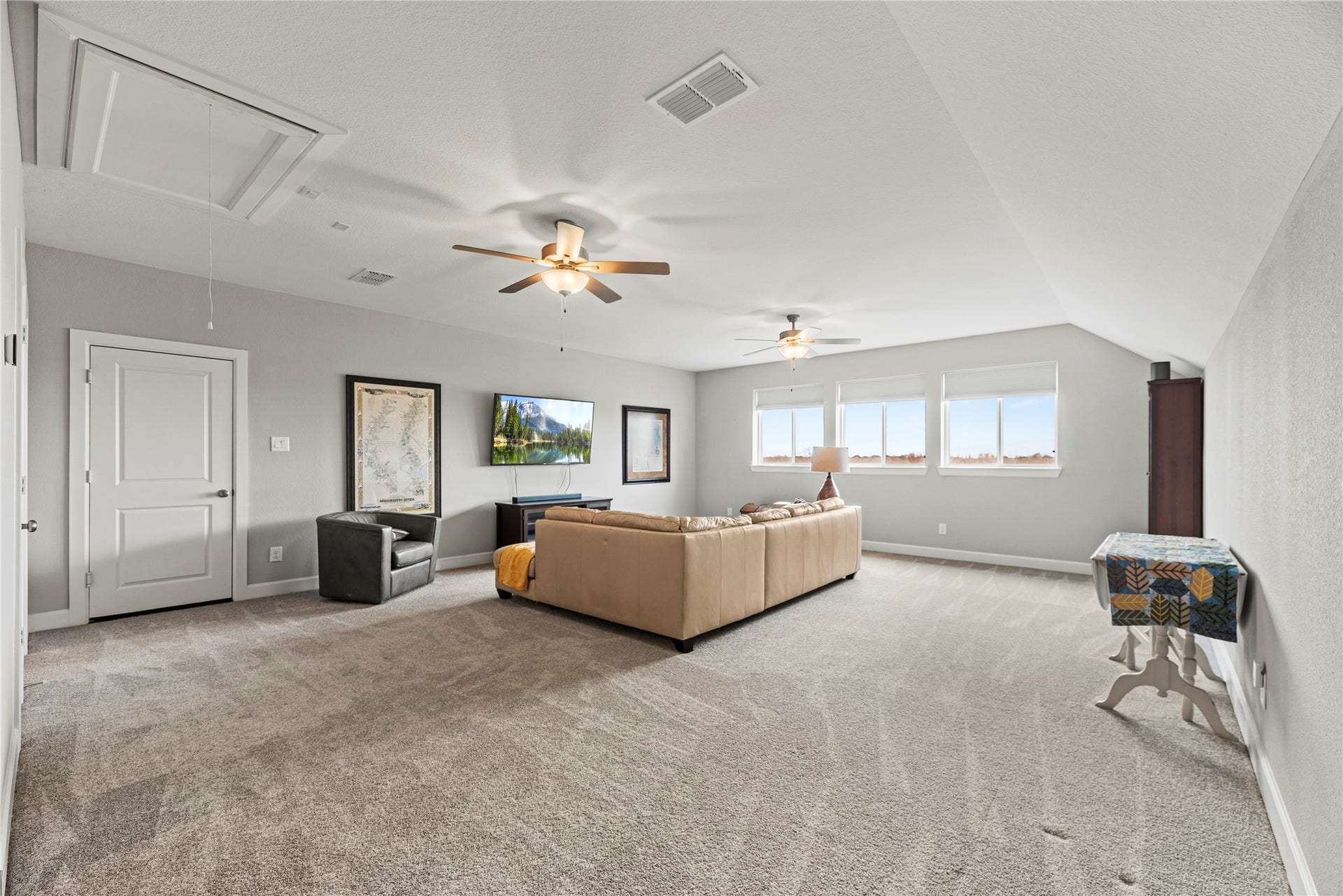 3127 Swift Way, Katy, TX 77493 Spacious and bright game/flex area featuring plush carpeting, neutral walls, and large windows offering ample natural light.