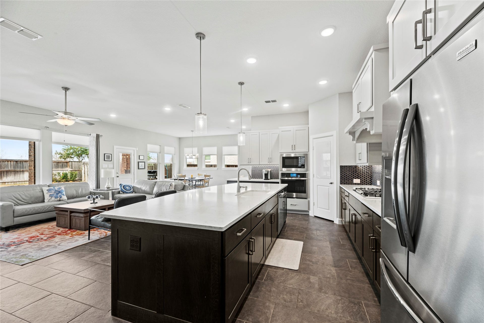 3127 Swift Way, Katy, TX 77493 Spacious open-concept kitchen and living area featuring a large island, modern appliances, and ample natural light, perfect for entertaining and gatherings.