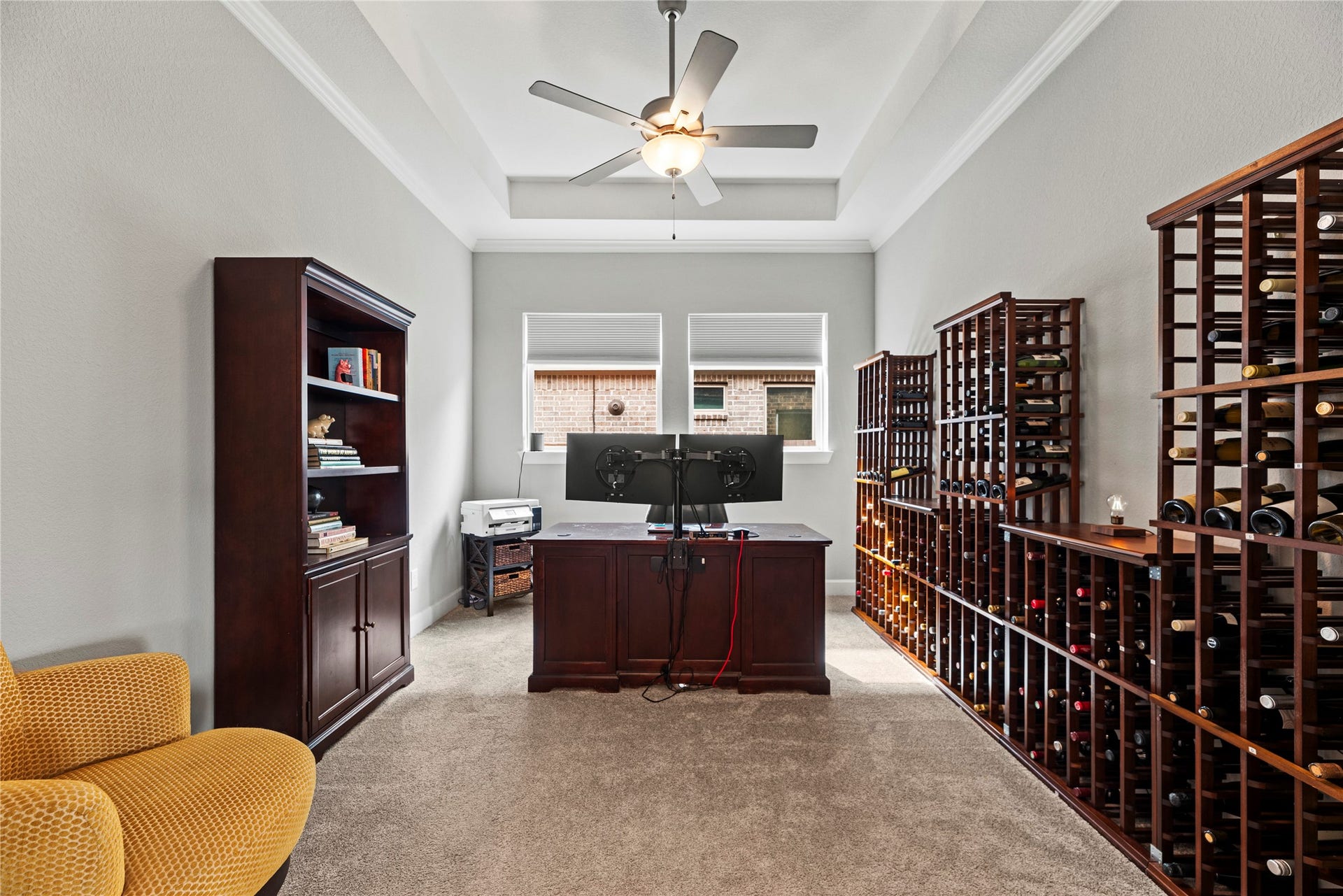 3127 Swift Way, Katy, TX 77493 Spacious home office / formal dining area featuring natural light, a stylish ceiling fan, and tray ceilings.