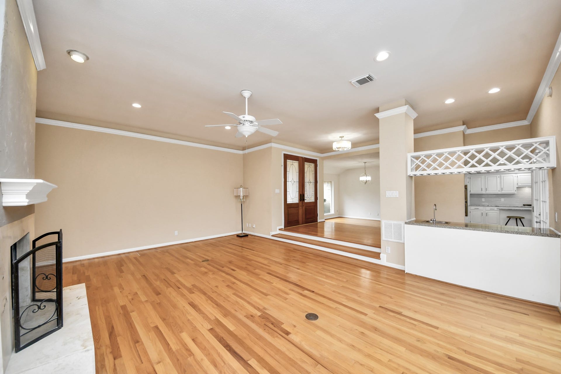 Unstaged view highlights the size of the living room and its open connection to the entry, dining area and wet bar.