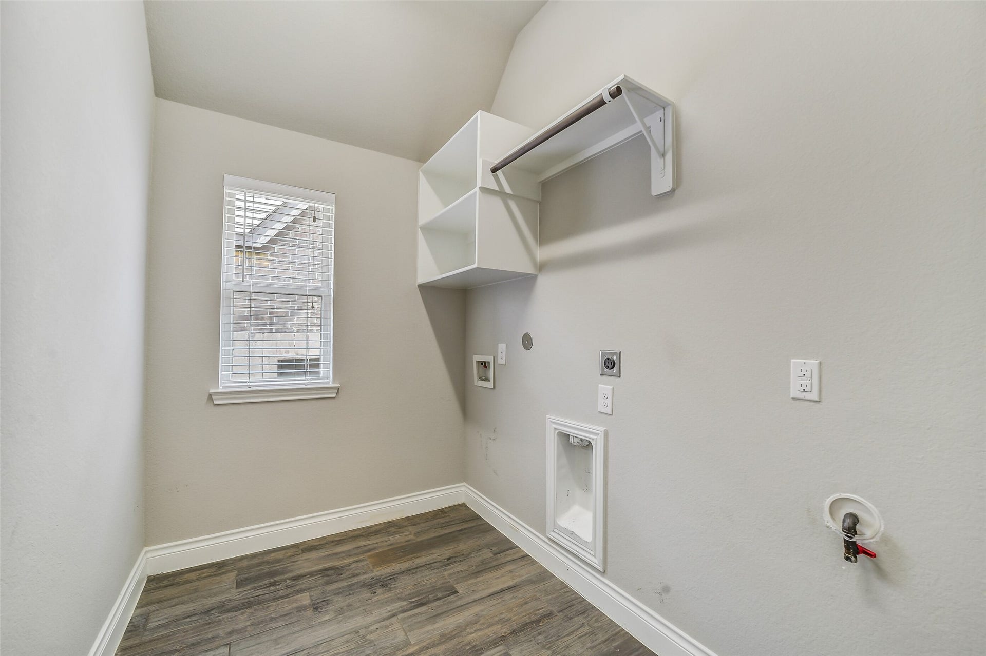 16818 Headwaters Forest Drive, Humble, TX 77346 Utility room with washer/dryer connections, built-in storage, hanging rack, and a window providing natural light.