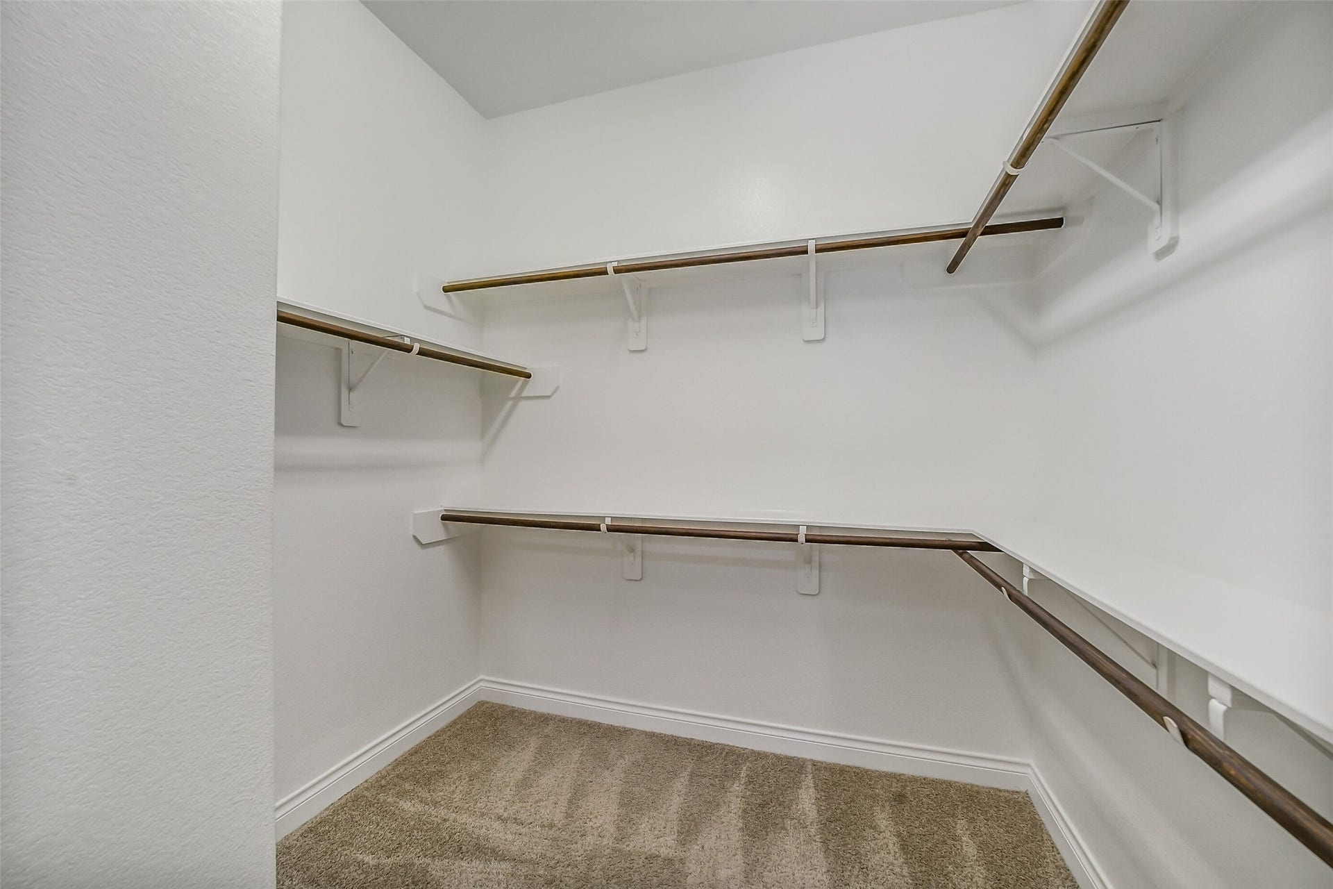 16818 Headwaters Forest Drive, Humble, TX 77346 Walk-in primary closet with abundant hanging space and built-in organization for effortless storage.