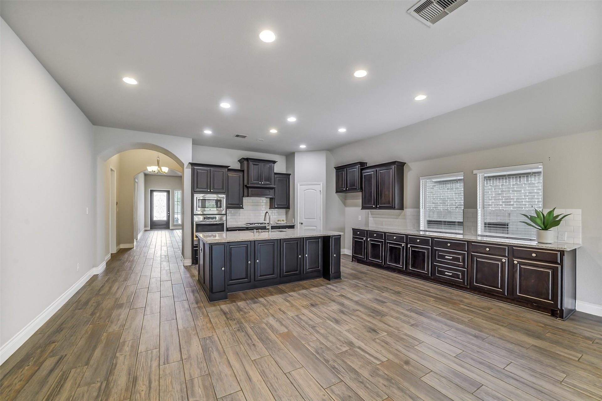 16818 Headwaters Forest Drive, Humble, TX 77346 Spacious open-concept kitchen and dining area with a large center island, abundant cabinetry, and clear flow for everyday living and entertaining.