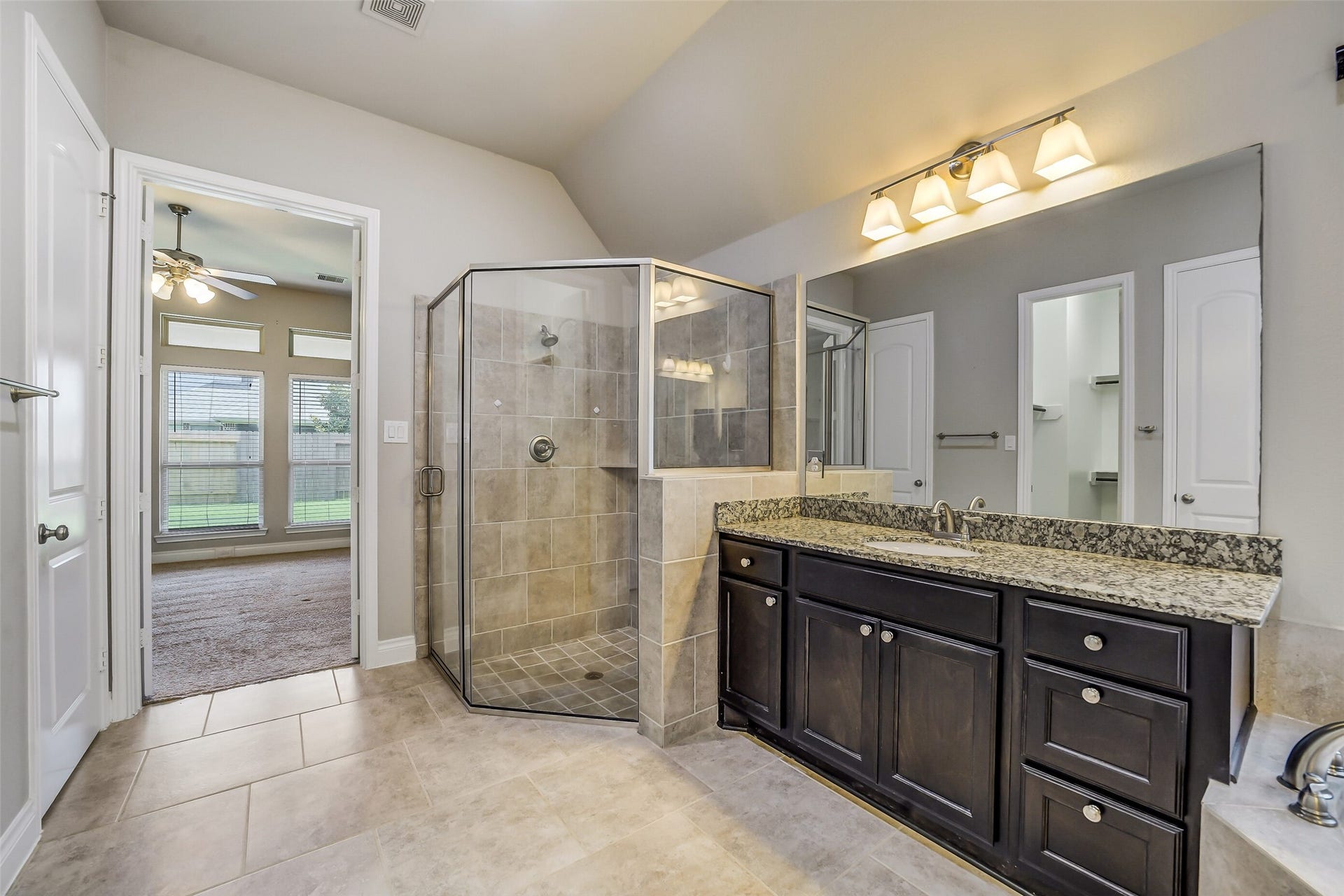16818 Headwaters Forest Drive, Humble, TX 77346 Spa-inspired primary bath with an oversized walk-in shower, granite vanity, and elegant finishes for everyday luxury.