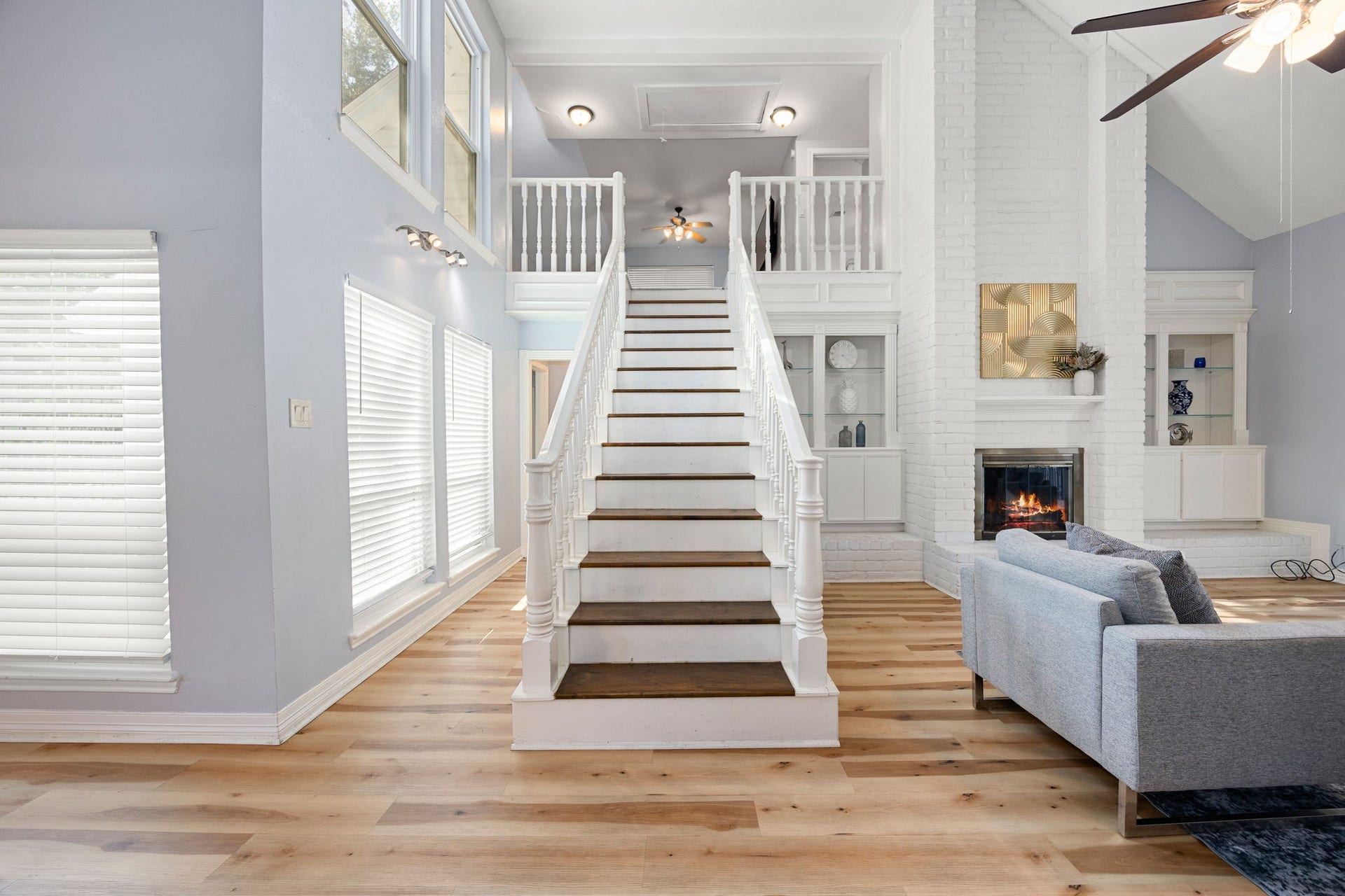 20102 Wickham Court, Katy, TX 77450 Two-story entryway with staircase, large windows, and fireplace