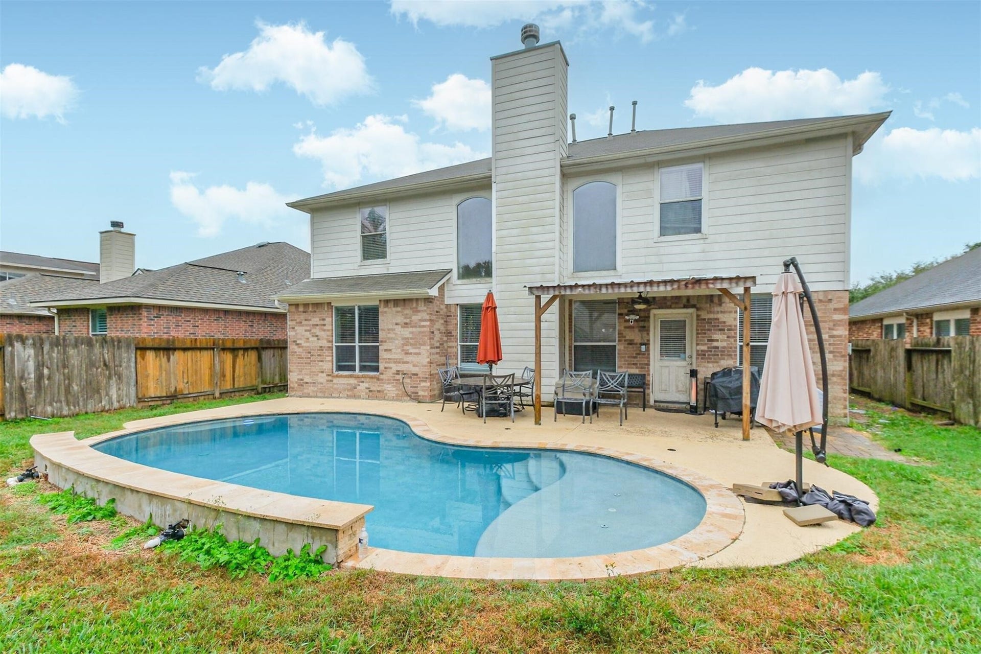 14907 E Lime Blossom Court, Cypress, TX 77433 With plenty of space for entertaining, grilling, or lounging poolside, this backyard is ready for making lasting memories.