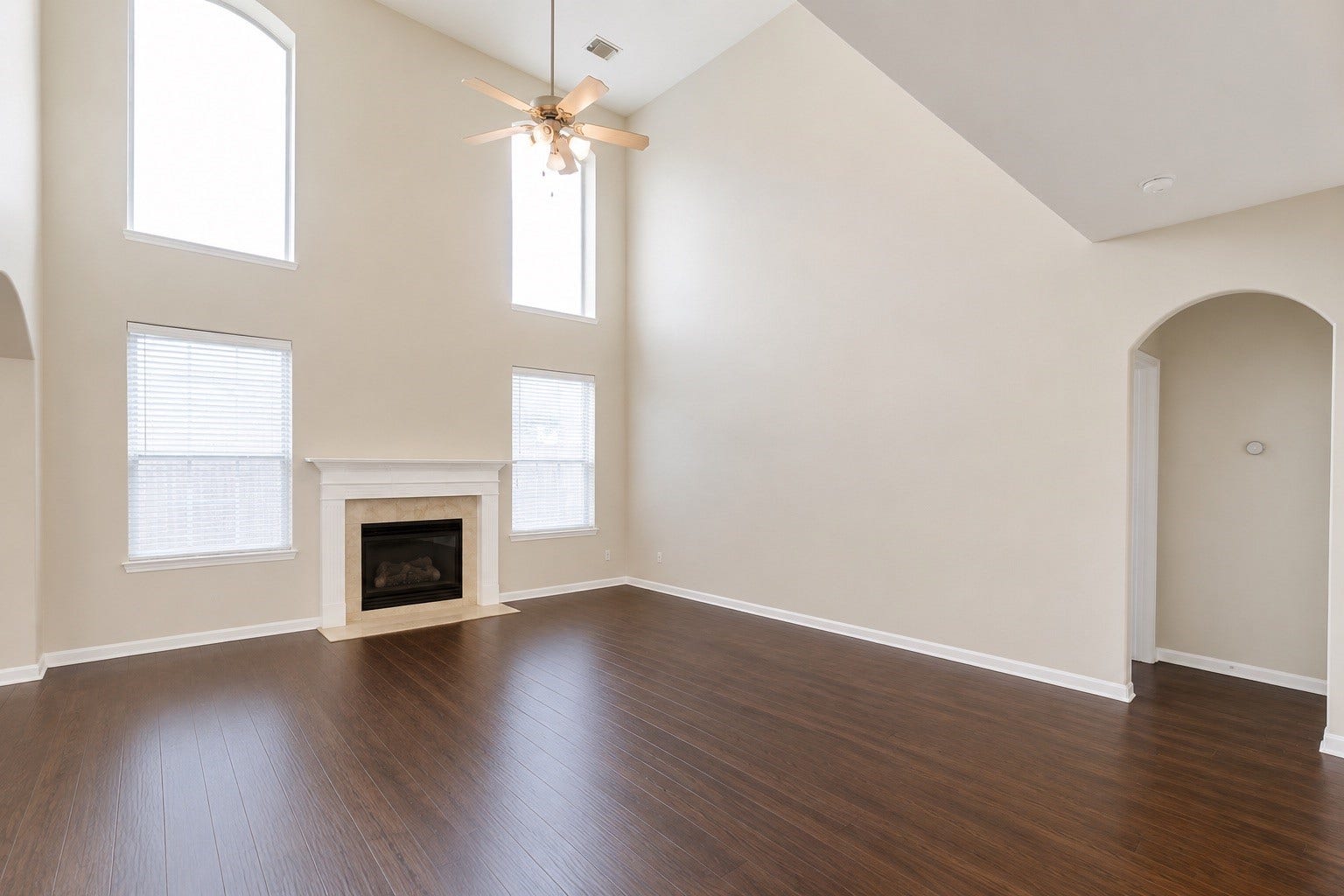 14907 E Lime Blossom Court, Cypress, TX 77433 The spacious living room features durable LVP flooring, a ceiling fan, and a stunning wall of windows.