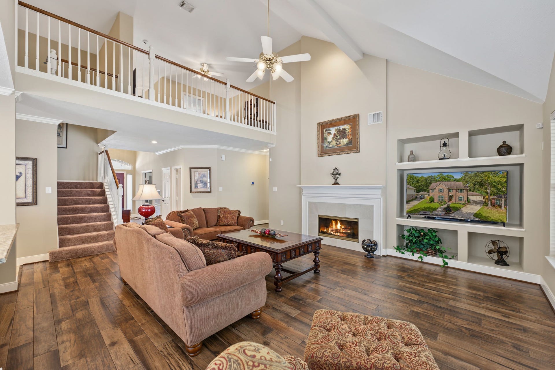 4807 Stonecrop Court, Houston, TX 77345 The vaulted ceilings make this Family Room feel even larger. Wood-look tile flooring throughout.
