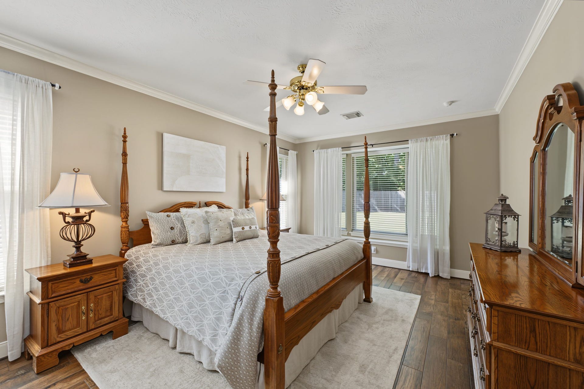 4807 Stonecrop Court, Houston, TX 77345 The Primary Bedroom measures approx 18' x 12' and contains wood-look tile flooring. Views to the backyard