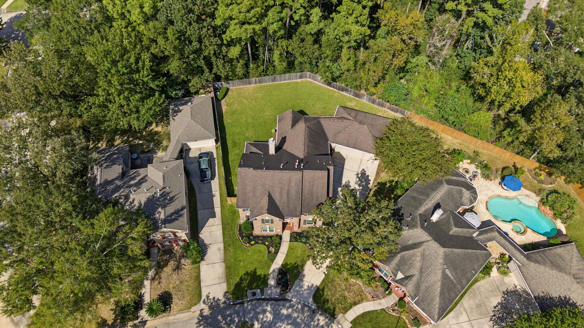 4807 Stonecrop Court, Houston, TX 77345 Aerial view showing the preserve of trees behind the back fence.