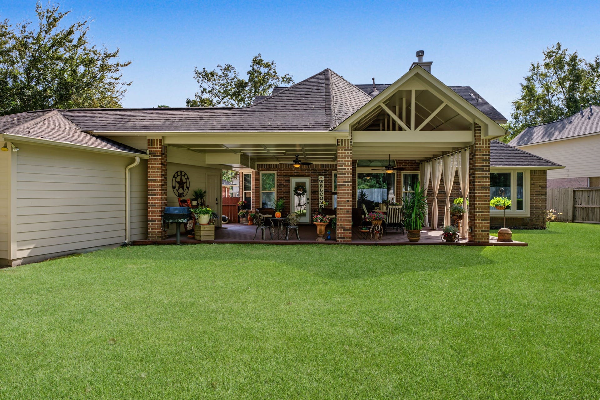 4807 Stonecrop Court, Houston, TX 77345 View from near the middle of the backyard grass space looking back onto the patio.