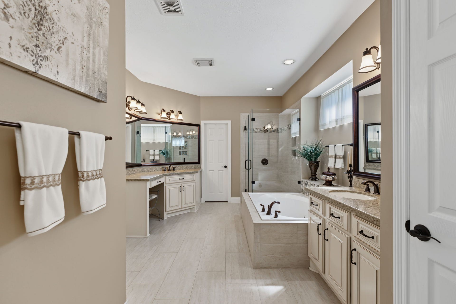 4807 Stonecrop Court, Houston, TX 77345 The Primary Bathroom is also updated with 2 completely separated vanity areas, a frameless shower, and jetted tub.