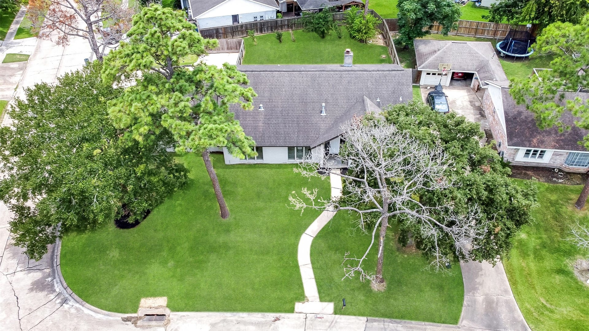 15503 Wandering Trail, Friendswood, TX 77546 Aerial views showcase this spacious 2-story home on a large corner lot with mature trees, fenced backyard, and prime Wedgewood Village location in CCISD.