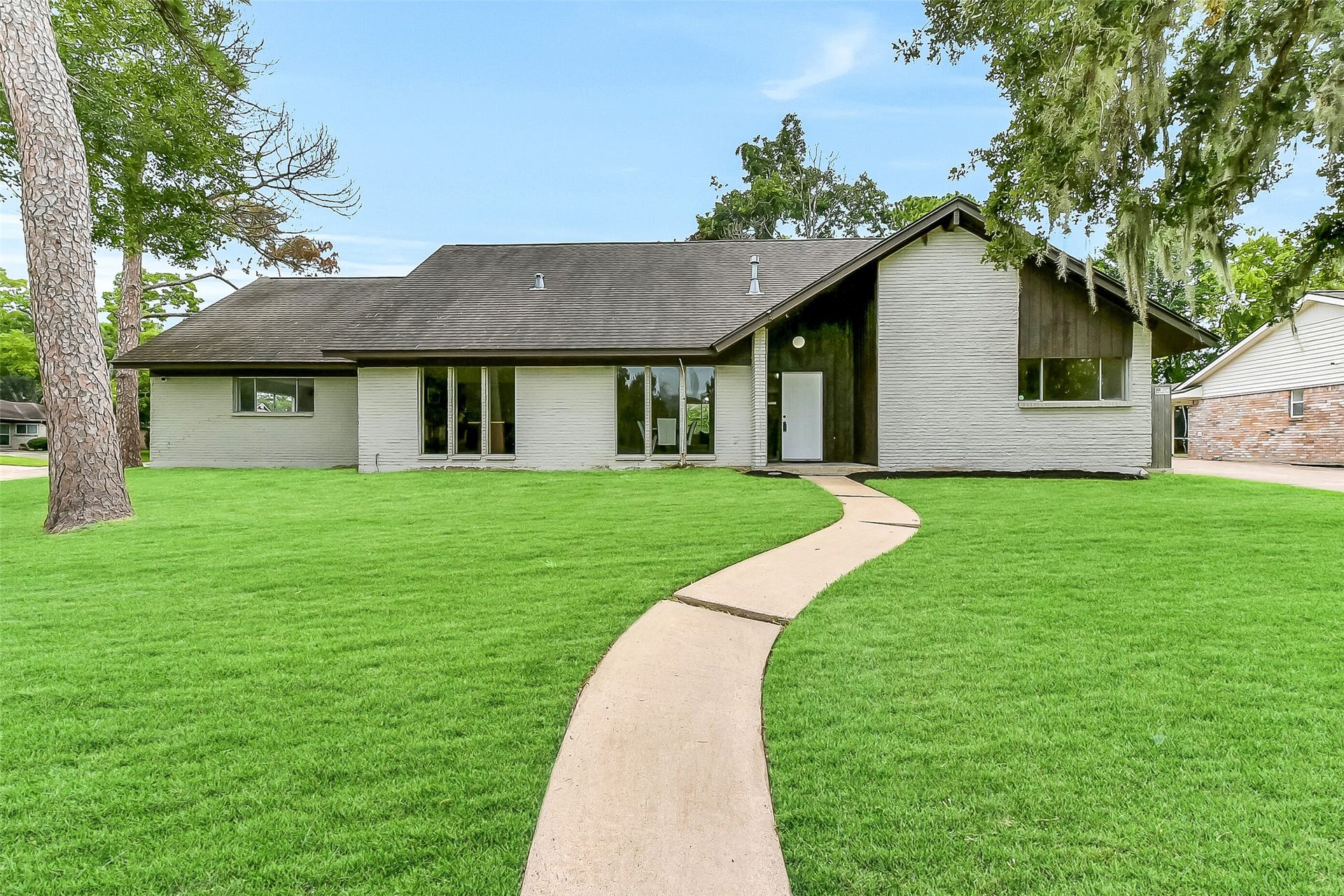 15503 Wandering Trail, Friendswood, TX 77546 Situated on a large corner lot with a high elevation in the established Wedgewood Village community, this two-story 5-bedroom home is framed by towering, moss-draped trees and offers a park like setting within the boudaries of CCISD.