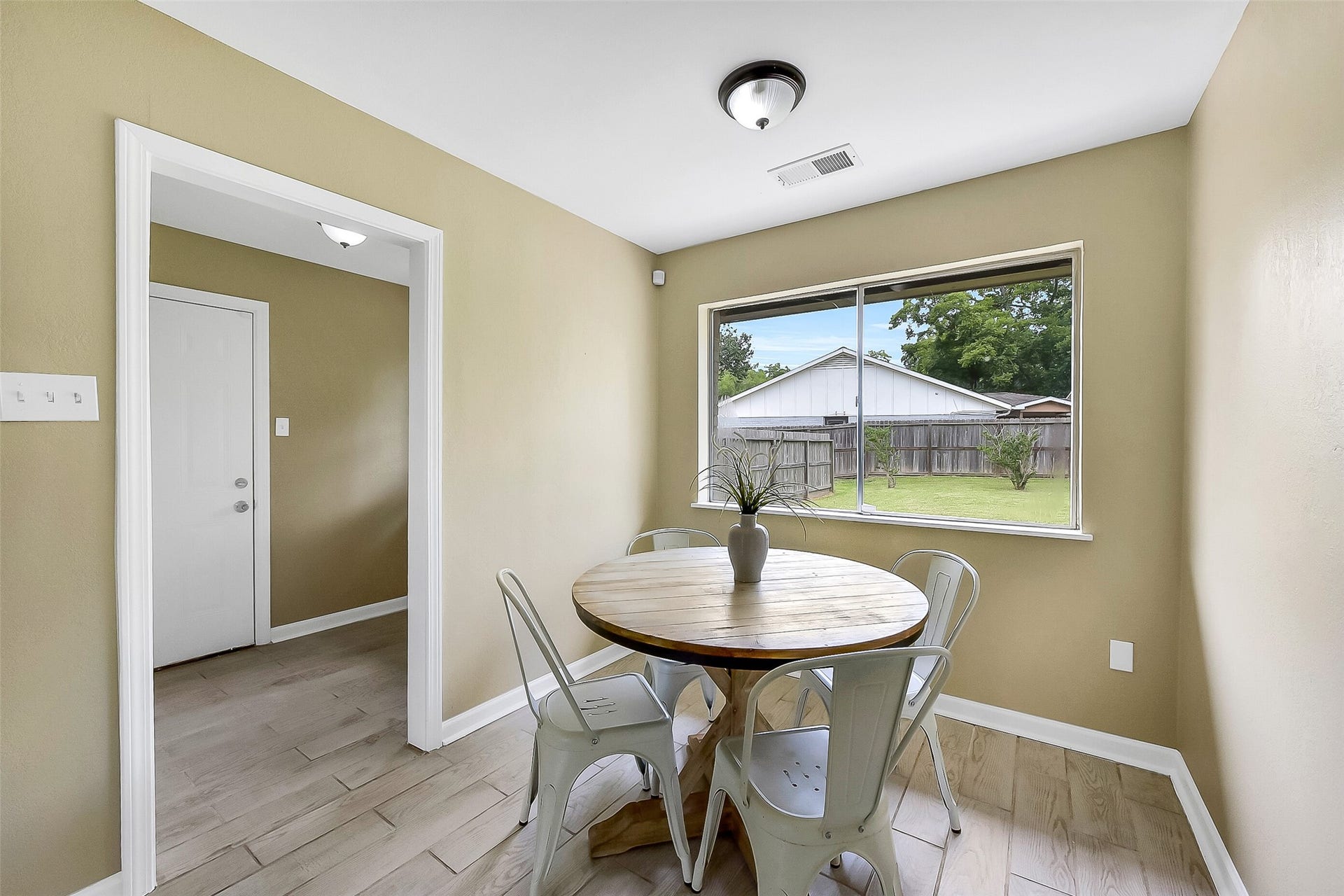 15503 Wandering Trail, Friendswood, TX 77546 This light & bright breakfast nook with wood-look tile floors and large windows overlooking the backyard is situated between the family room, the indoor utility room, and the kitchen.