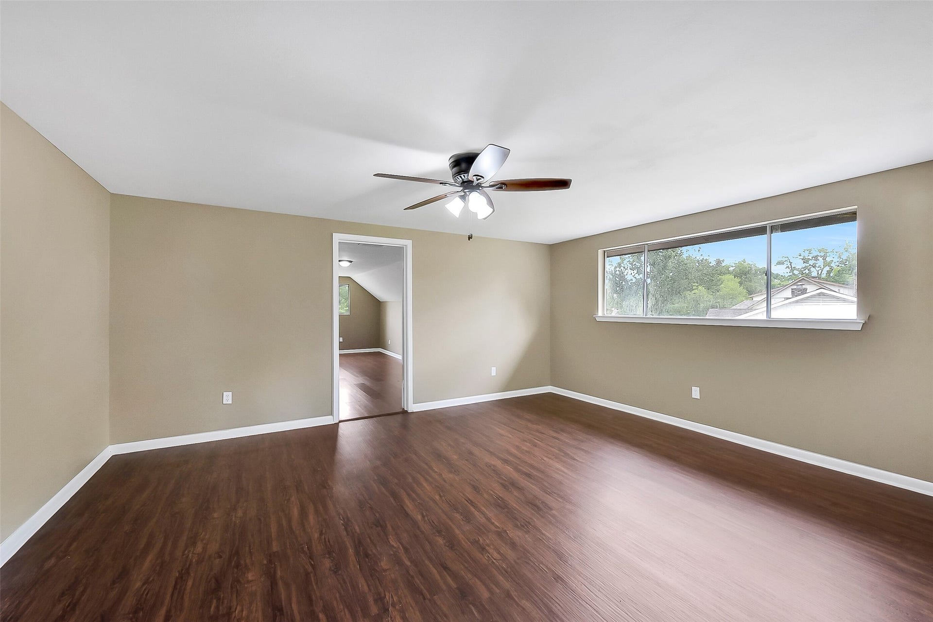 15503 Wandering Trail, Friendswood, TX 77546 Spacious fourth bedroom upstairs with wood-look flooring, ample natural light, and an attached bonus room that offers endless possibilities for a study, playroom, or private retreat.
