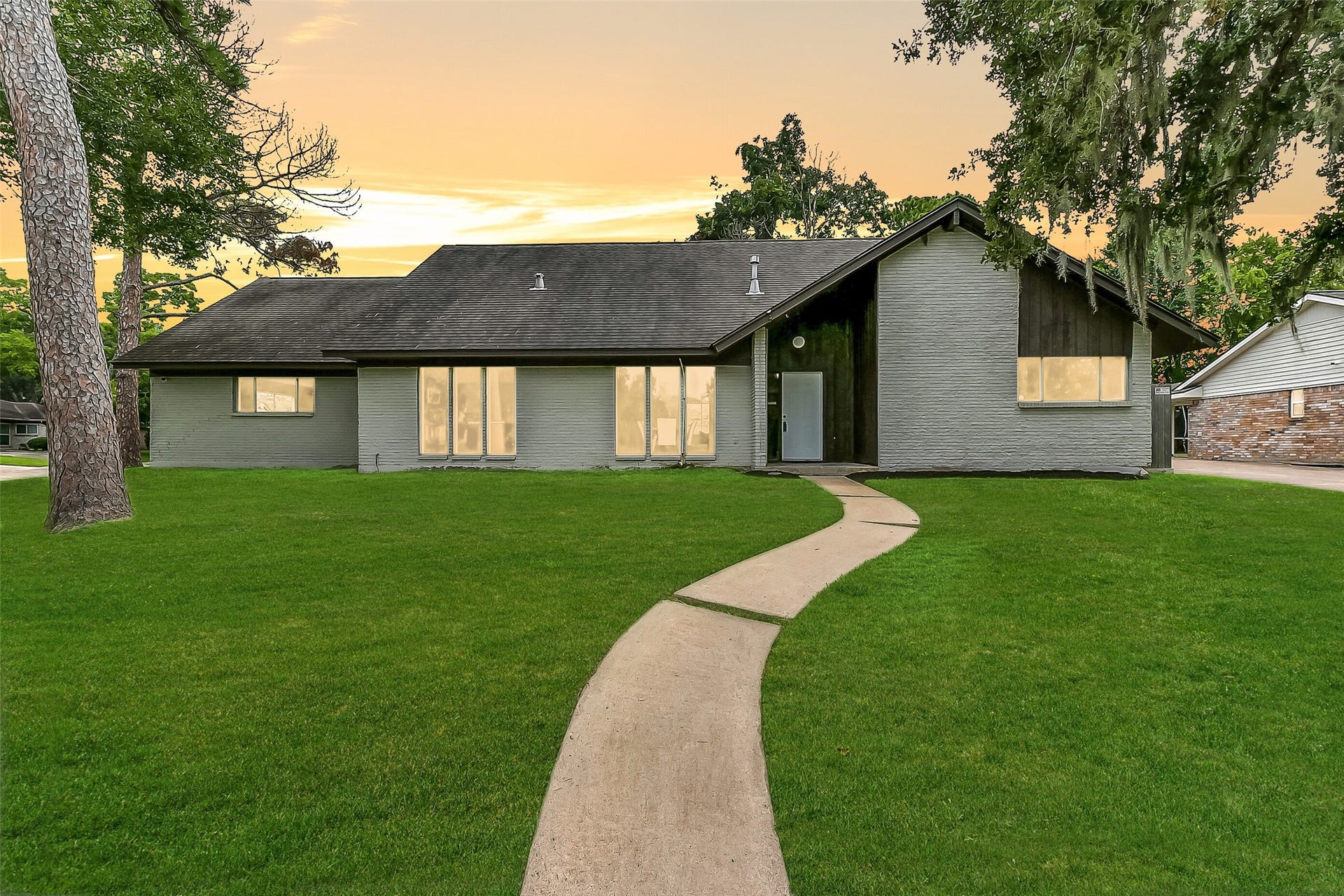 15503 Wandering Trail, Friendswood, TX 77546 Situated on a large corner lot with a high elevation in the established Wedgewood Village community, this two-story 5-bedroom home is framed by towering, moss-draped trees and offers a park like setting within the boudaries of CCISD.
